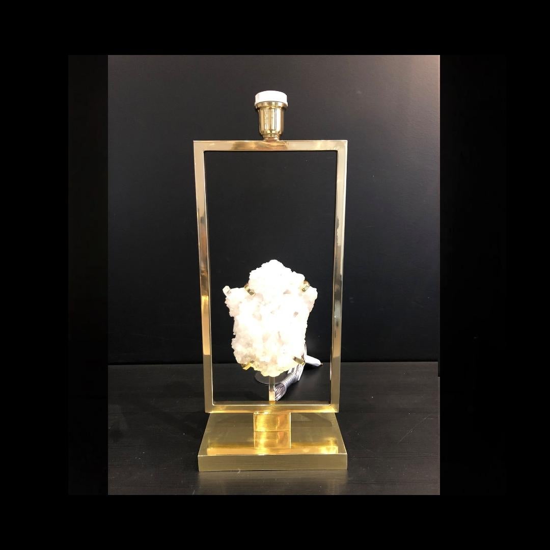 Artist's table lamp created with selected white rock crystal druse. Beautiful base and frame in polished brass.

The process of creation goes through several craftsmen before reaching the final stage, and each craftsman is specialized in one