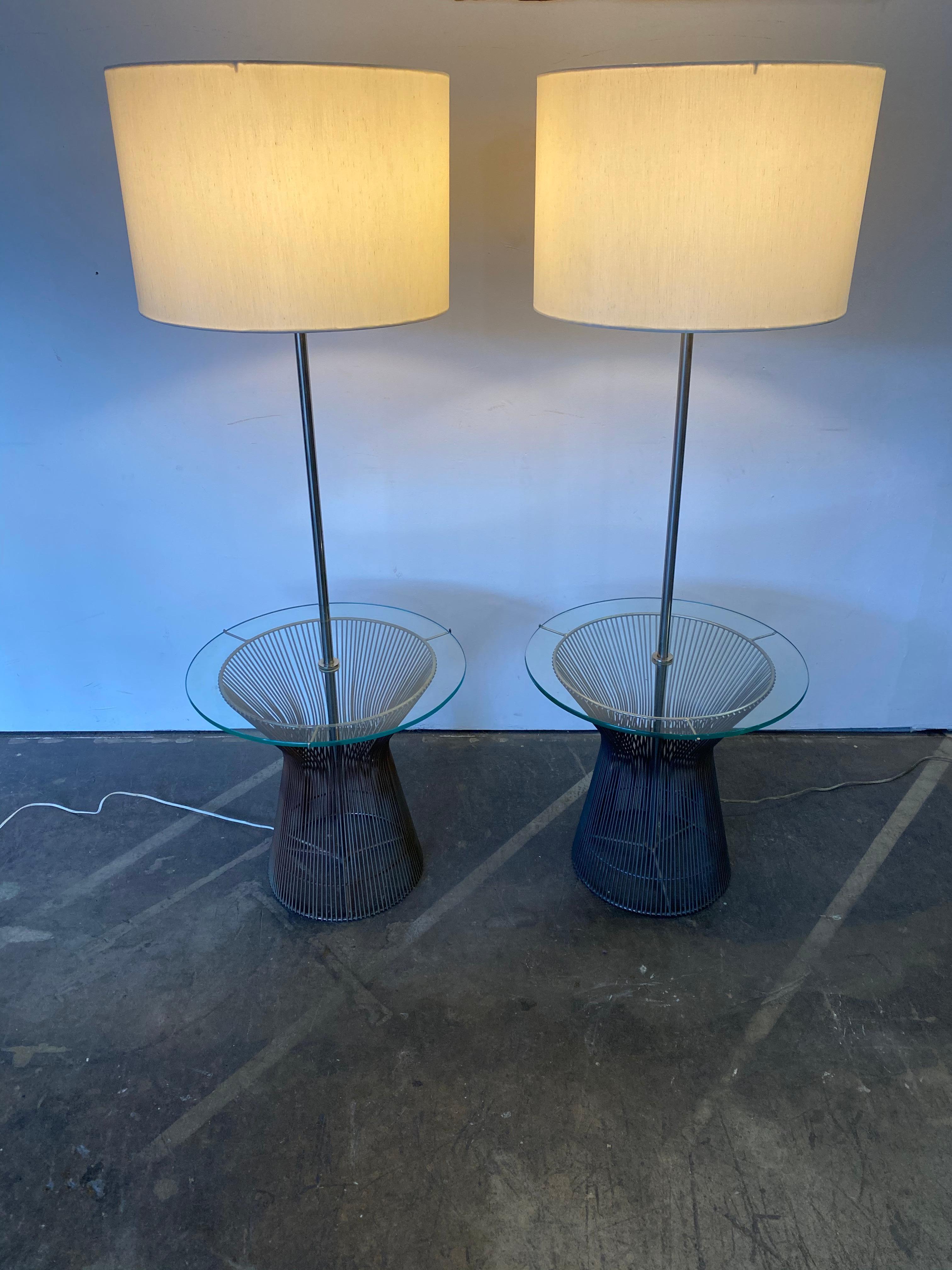 Gorgeous and rare pair of floor lamps by Laurel Lamp Company. Metal rod bases in the style of Warren Platner, supporting original glass tray tables. New shades. Both tested and working, and accommodate traditional and modern light bulbs.