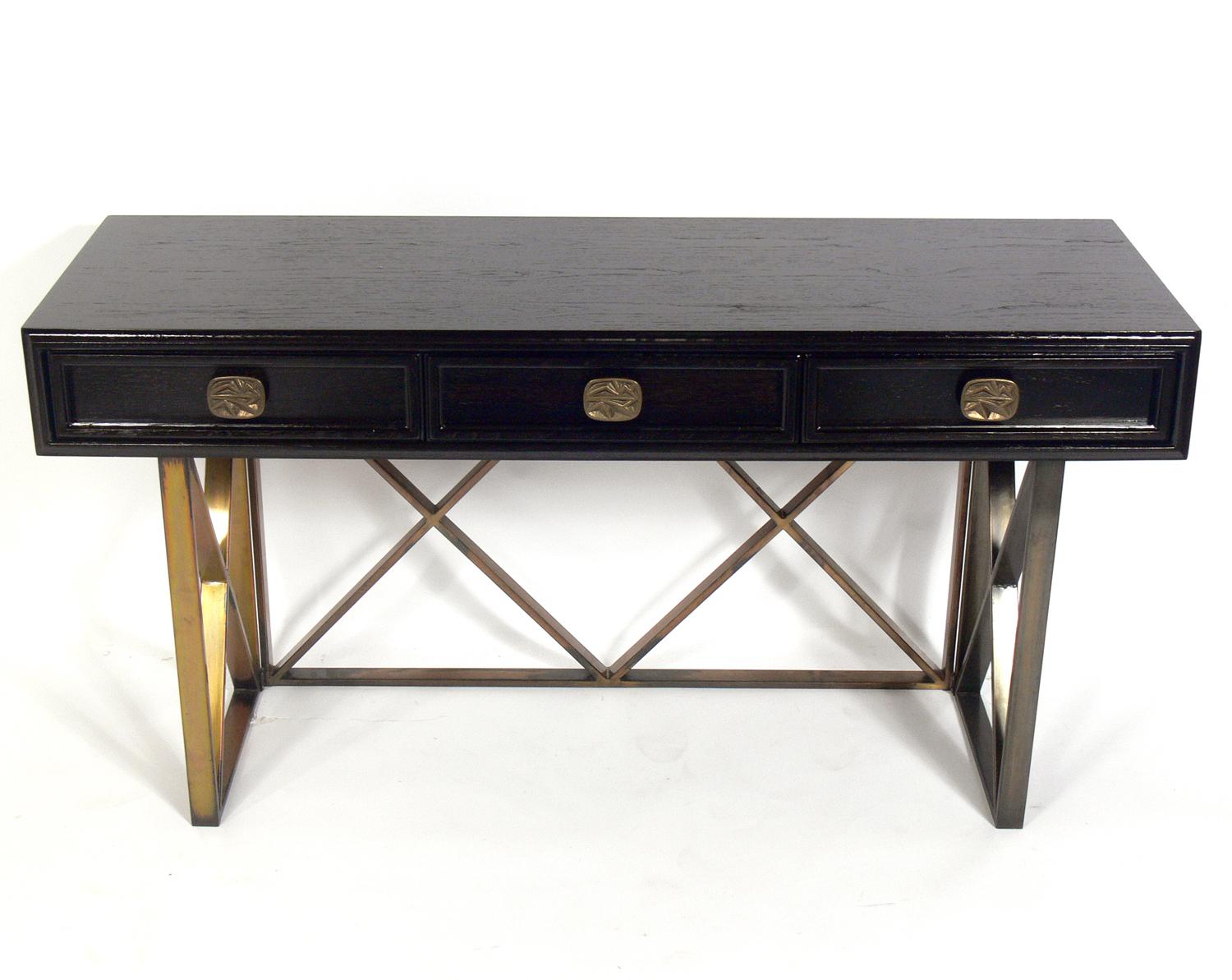 Elegant console table or desk, American, circa 1950s. This piece is a versatile size and can be used as a console table, desk, sofa table, bar, or vanity. It has been refinished in an ultra-deep brown lacquer and retains it's original patina to the