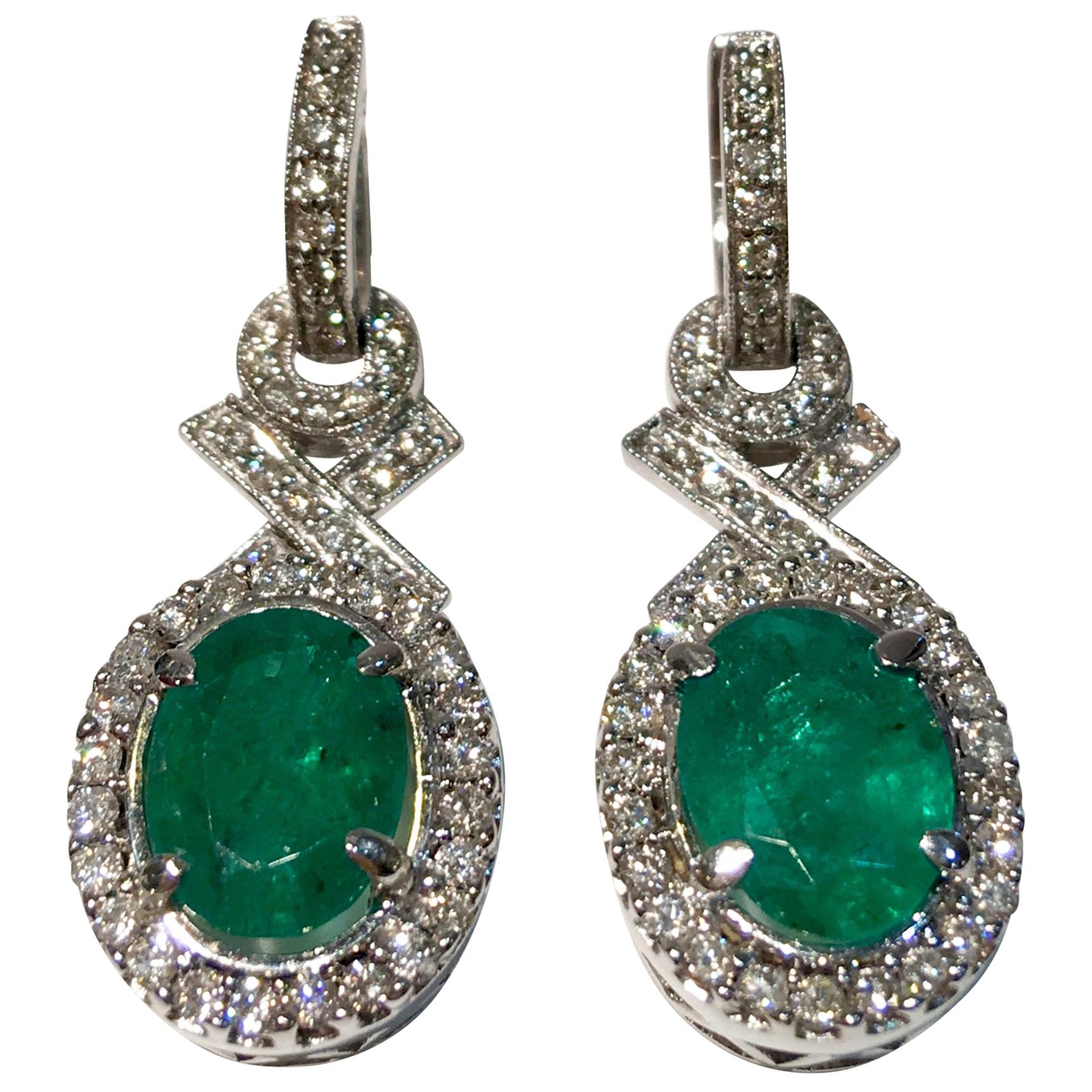 Elegant "XO" Oval Emerald and Diamond Halo 18 Karat White Gold Drop Earrings