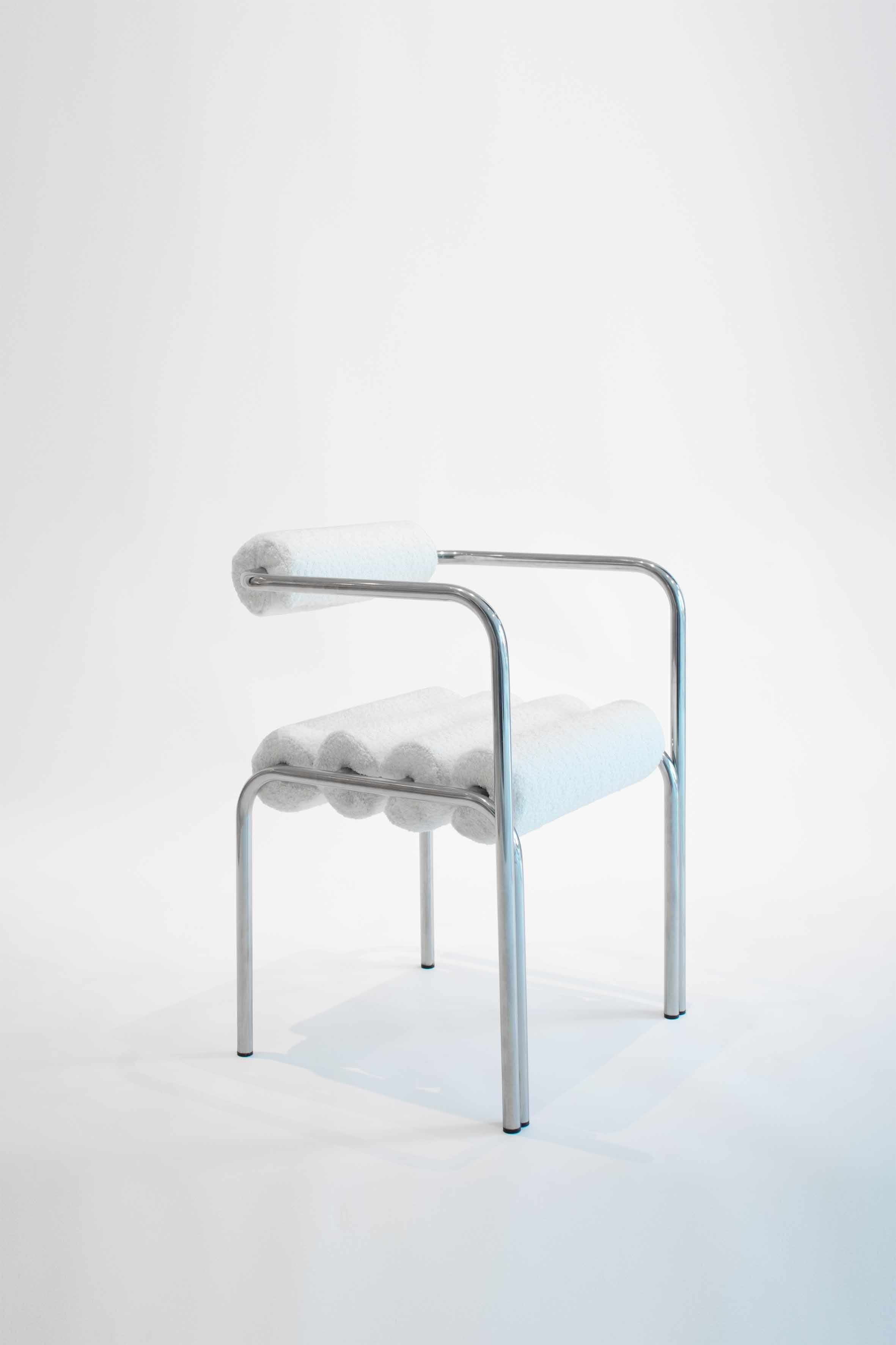 Elegg tubular chair C by Studio Christinekalia
Dimensions: W 50 x D 50 x H 85 cm.
Materials: Stainless steel, bouclé fabric. 

Austere in appearance yet cordial to the human body, this chair design follows the metallic path of its tubular