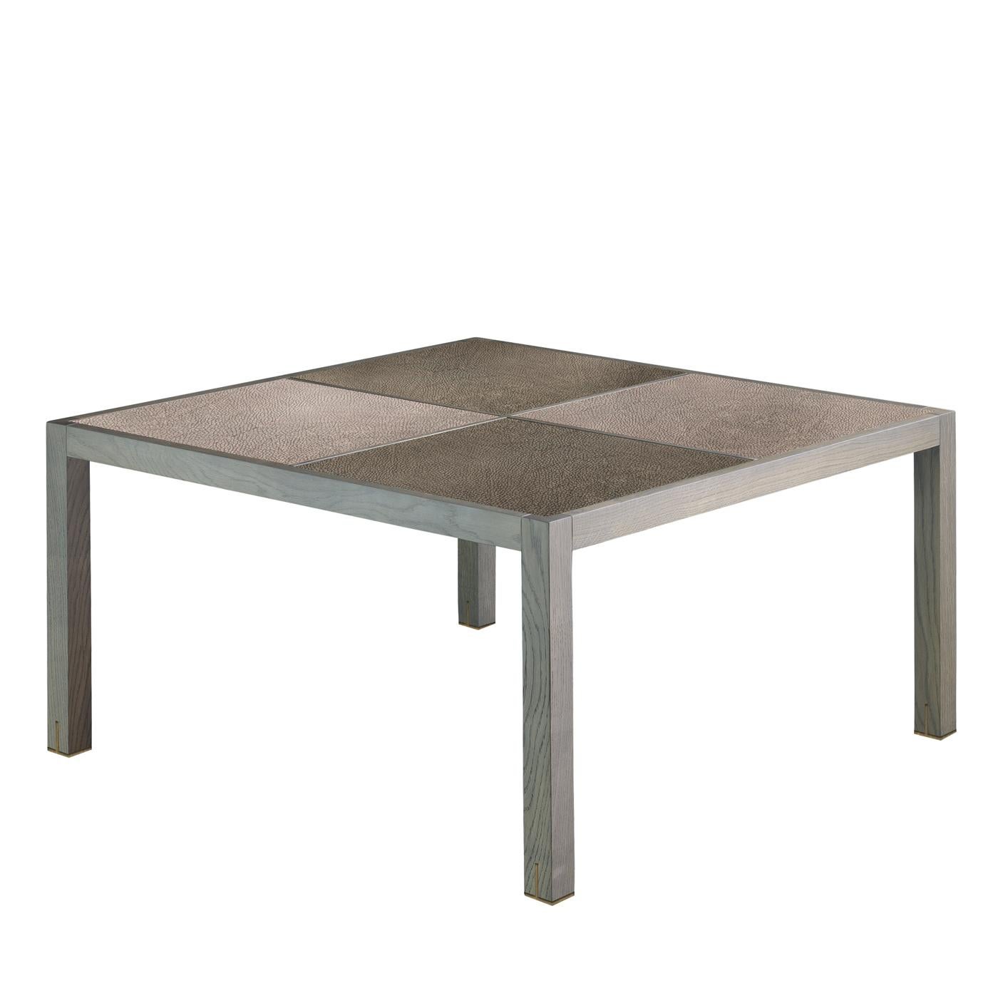This coffee table is a versatile and timeless piece that will imbue a living room with refined sophistication. Its unique, eclectic allure is marked by a checked top alternating two squares covered with fine leather and two with stained oak. This