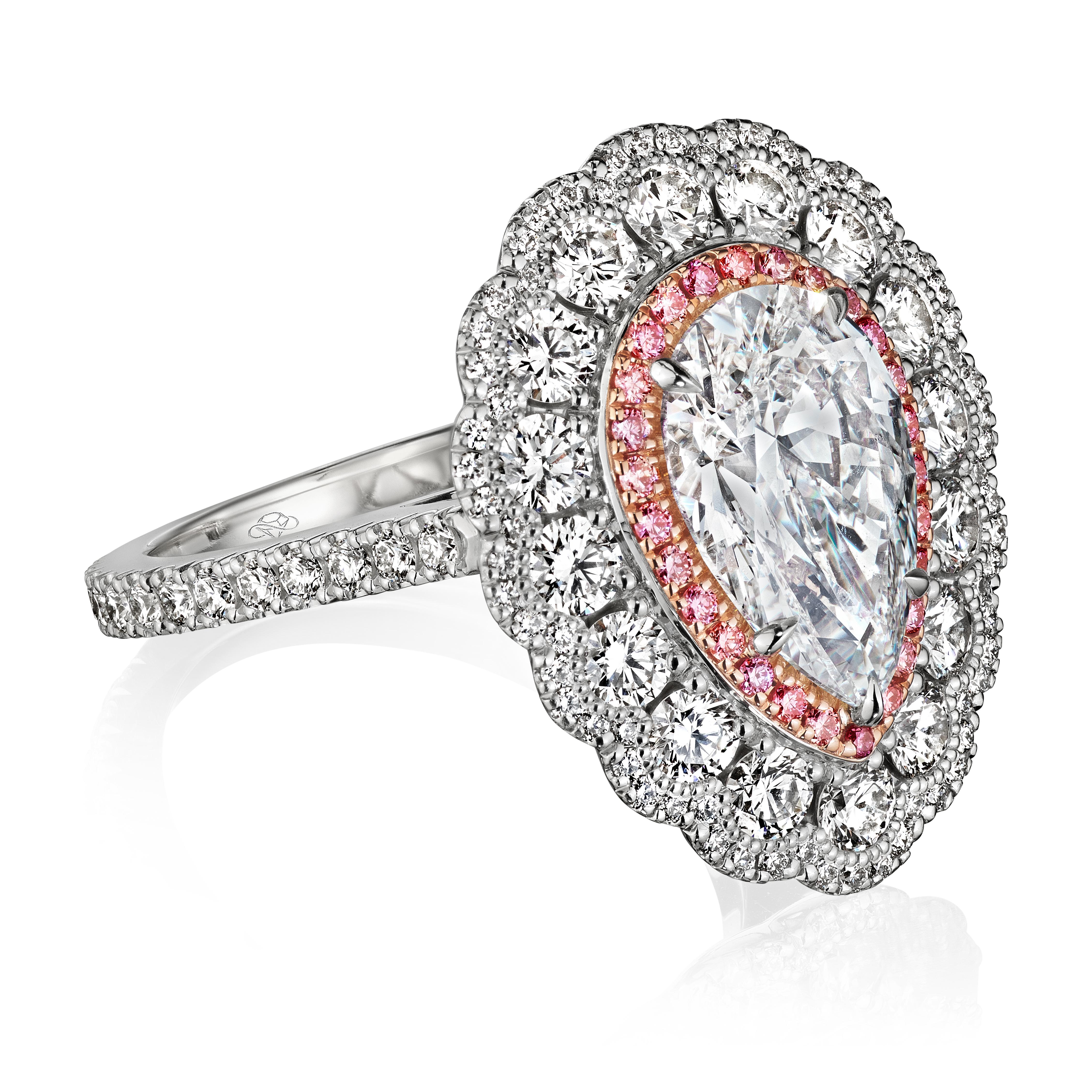The eye-catching scalloped edges and addition of pink diamonds make The Elena stand out from the crowd. The stunning triple halo of this cathedral setting provides additional finger coverage in comparison to single halos, giving it both a vintage