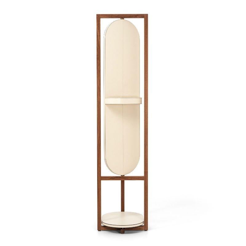 Elena, the new valet stand especially thought for Her. After the Achille style we are glad to enrich our collection with a more feminine version. The elegant walnut wood structure is now taller and embellished by a revolving mirror refined on the