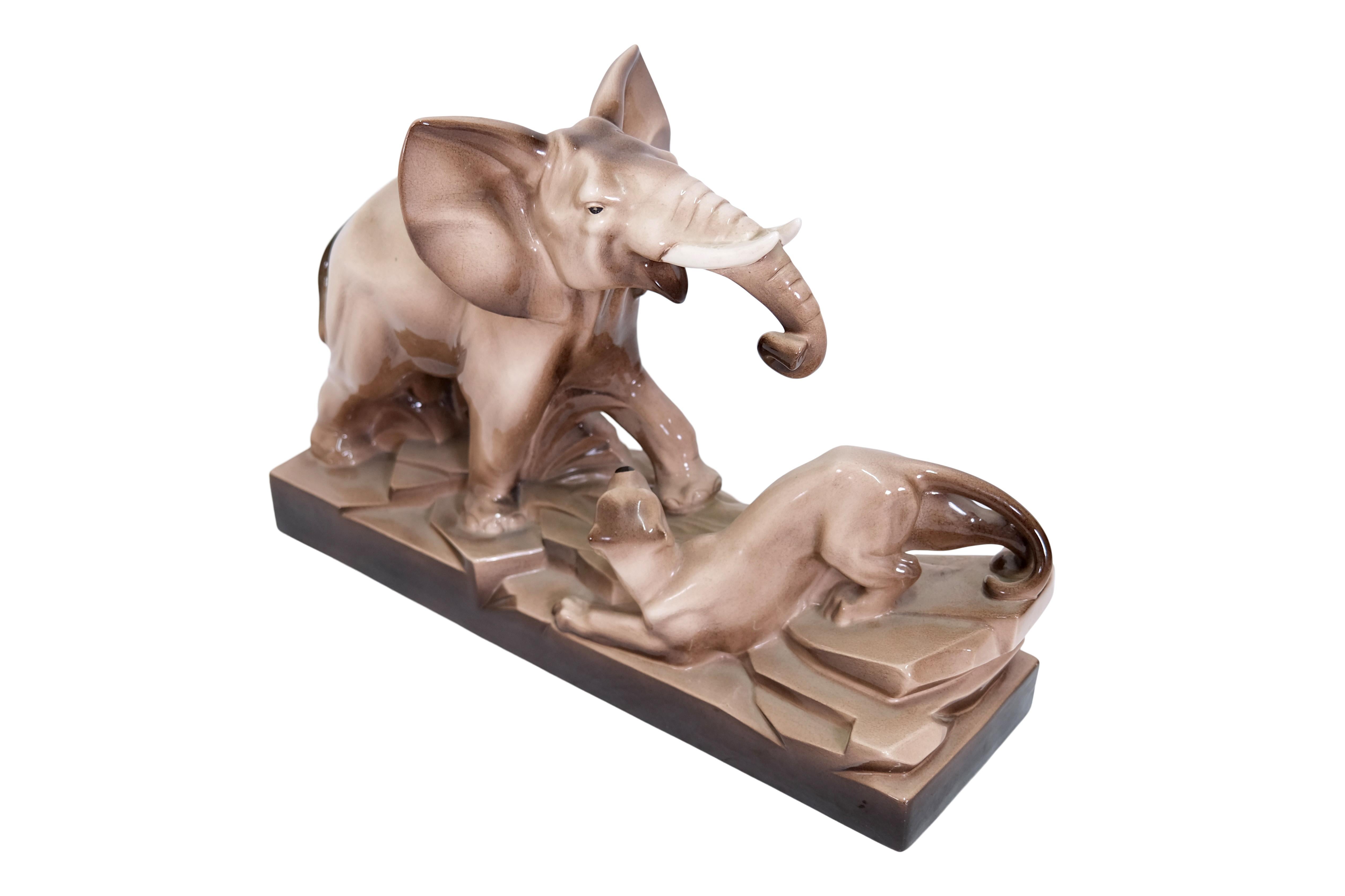 Large ceramic sculpture with cream colored glaze
Elephant and panther

Original Art Deco, France 1930s

Dimensions:
Width: 54 cm
Height: 37 cm
Depth: 21 cm.