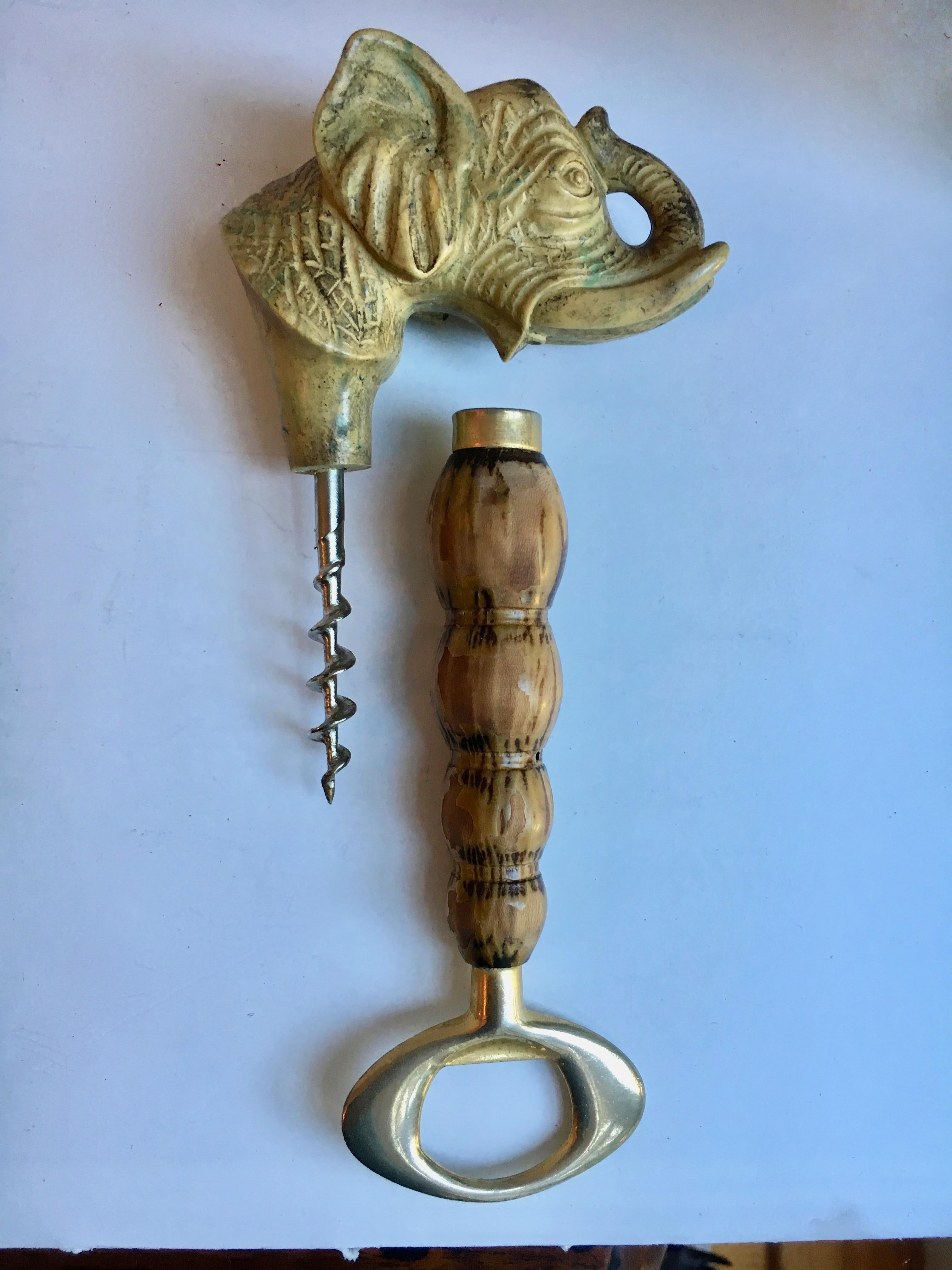 Elephant brass bottle wine opener, a resin elephant with brass and wood details.
The head unscrews to become a wine corkscrew opener.