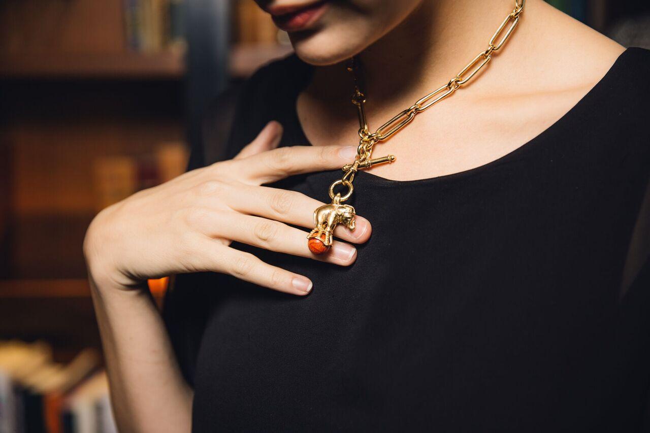 Dudley VanDyke's Elephant Fob is featured in 14K Yellow Gold with a red Sponge Coral ball. The Elephant Fob is also available by custom order in Sterling Silver. This piece is typically made to order, though we may have one in stock. For an accurate