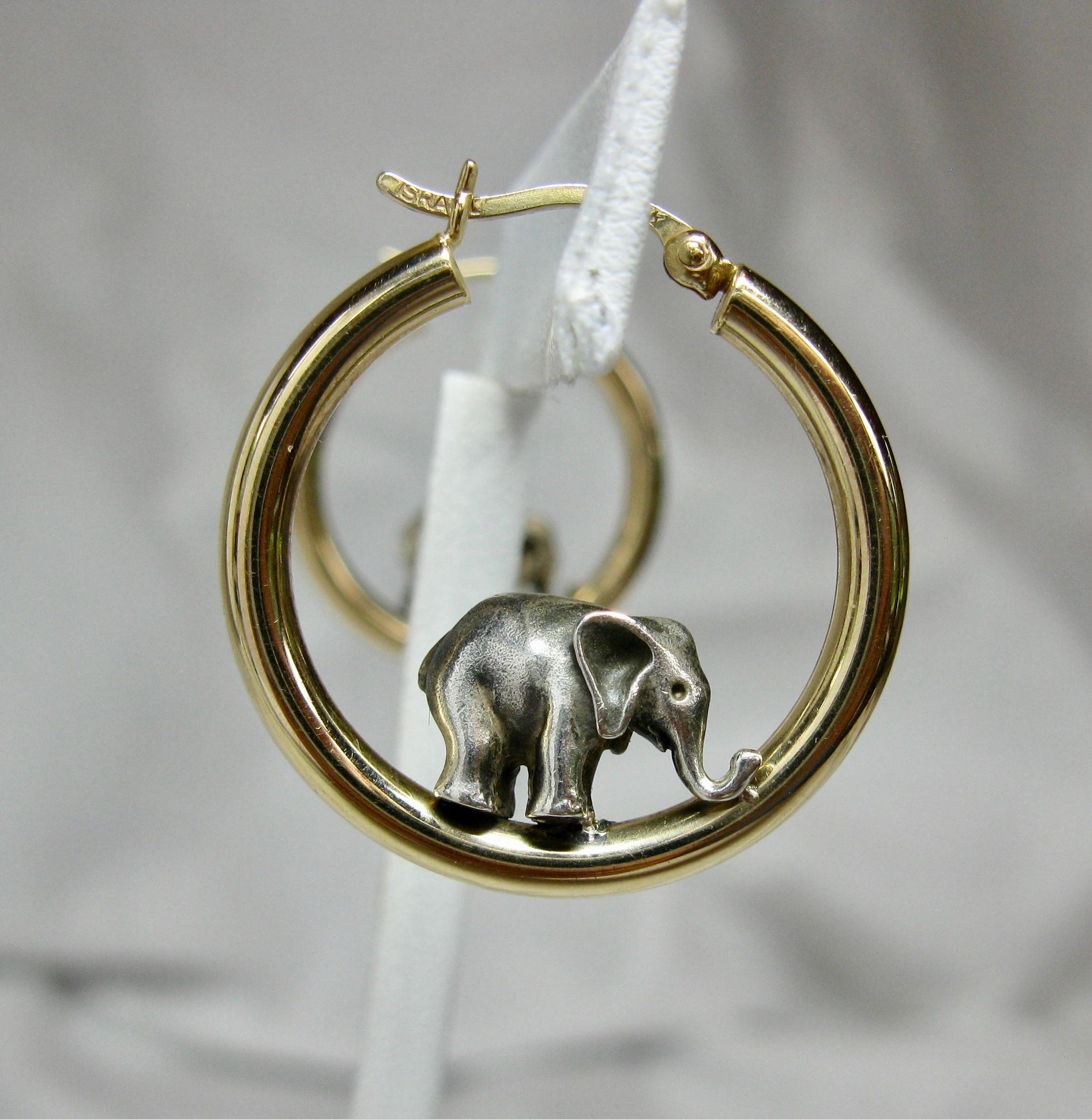 A charming pair of Elephant Earrings.  The adorable elephants are Sterling Silver and set in 14 Karat Yellow Gold Hoops.  How wonderful!

The earrings are 1 inch (26mm)  in diameter.
They are hallmarked PBD 925 14K Israel