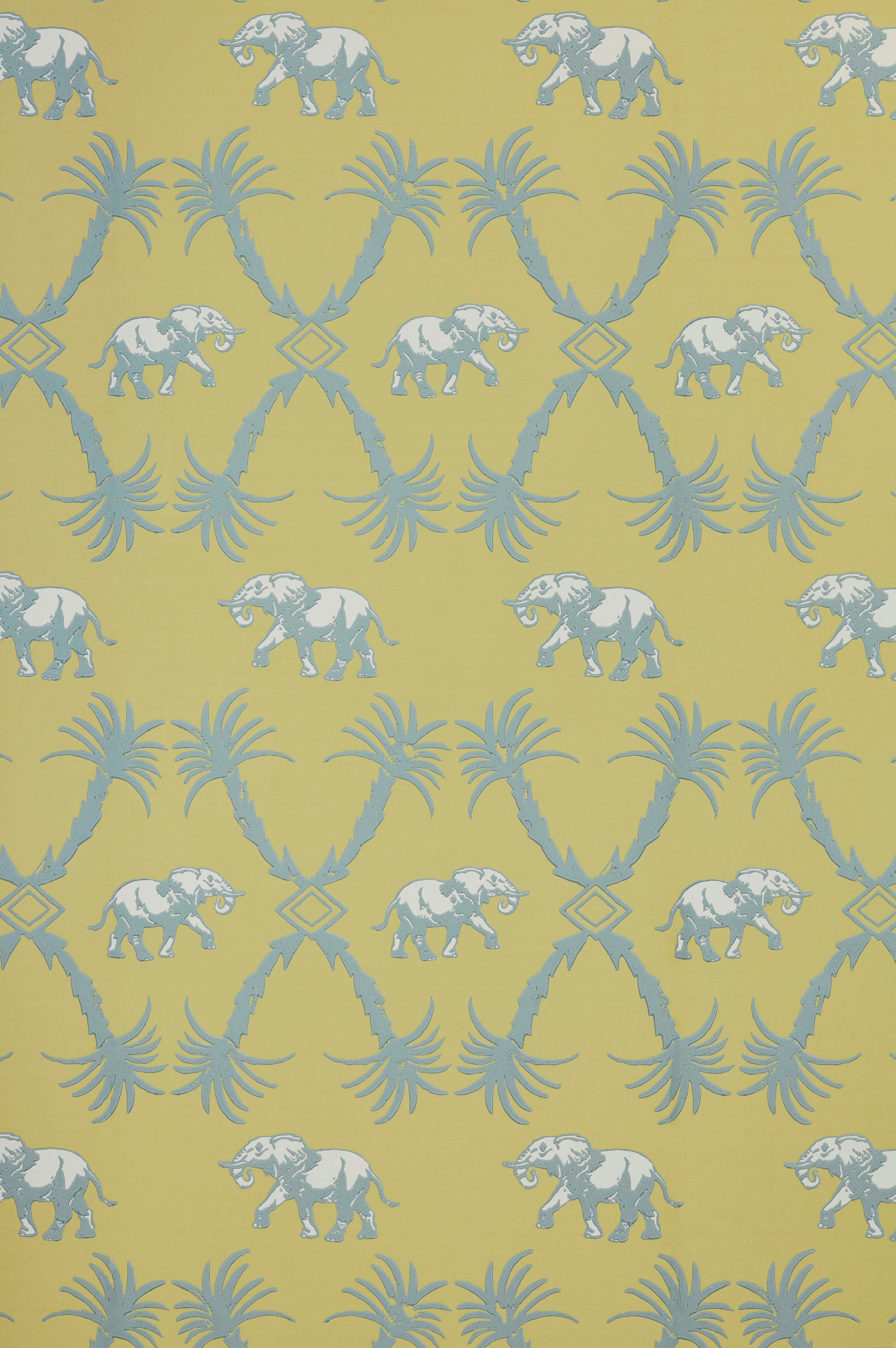 Color: Ochre/Blue 
Measures: Trim width 52cm/20.5 inches
Roll length 10m
Pattern repeat: Straight
Match length: 52cm/20.5 inches.

Please get in contact to order a sample.

A colonial inspired trellis of palm trees and marching elephants,