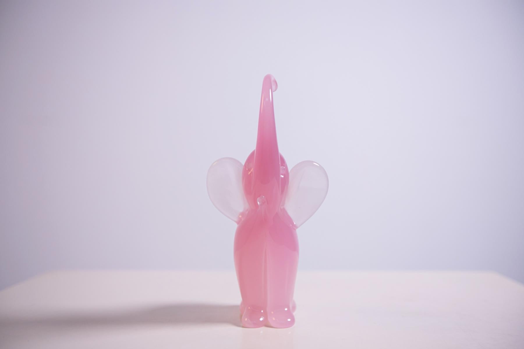 Beautiful baby elephant sculpture, designed and made by Italian master glassmaker Archimede Seguso in 1950s in fine light pink Murano glass, using special freehand Murano glass techniques.
The elephant is represented with the trunk stretched