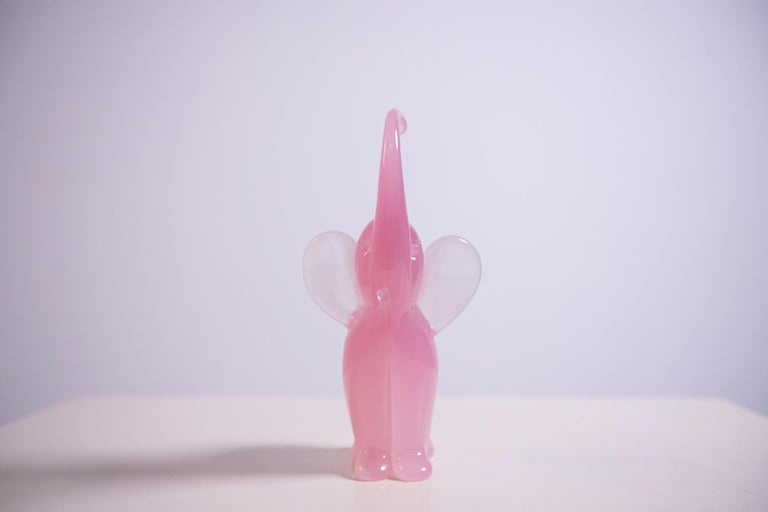 Beautiful baby elephant sculpture, designed and made by Italian master glassmaker Archimede Seguso in 1950s in fine light pink Murano glass, using special freehand Murano glass techniques.
The elephant is represented with the trunk stretched