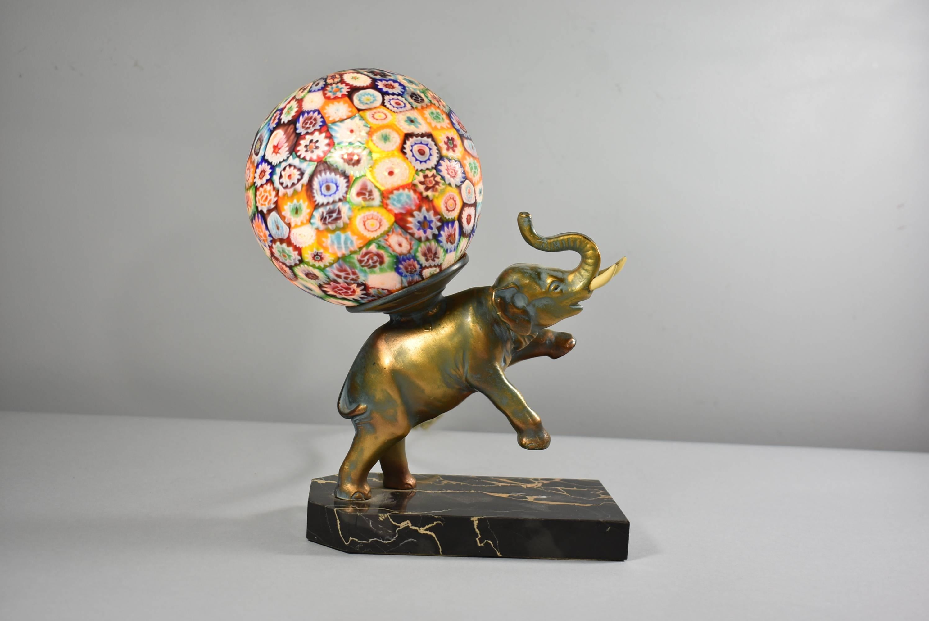 Antique elephant figural lamp with Murano Millefiori glass circular shade / globe. Metal elephant with original finish with faux tusks and a marble base. Made in Italy. Very good condition with minor wear from age. Good wiring.
 
