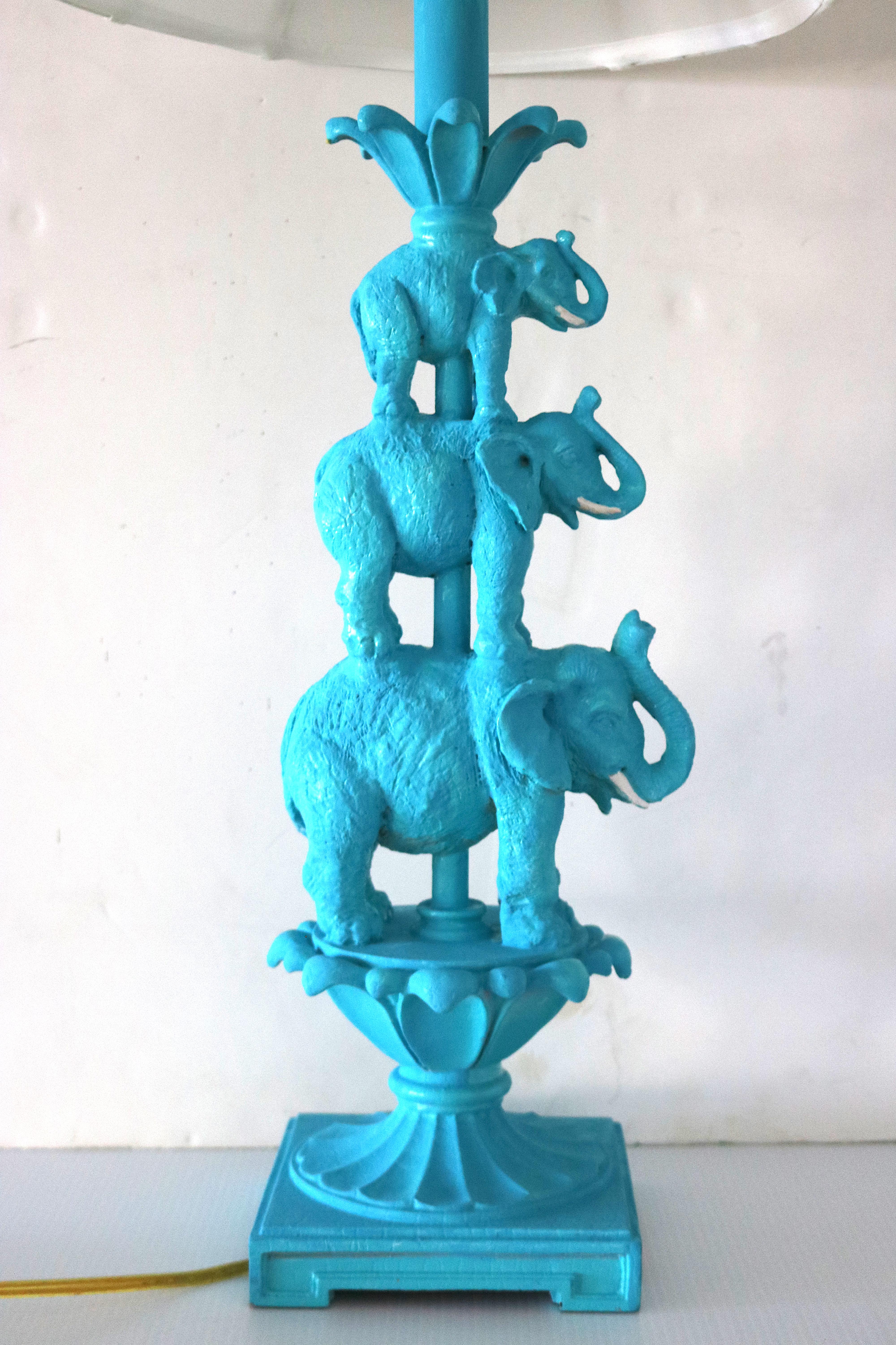 Unique(may be one-of-a-kind) sculptural artisan textured cast elephants stacked-daddy, mommy, baby-trunks up- with a charming decorative design painted turquoise with white painted tusks, a tulip shaped white on white striped lamp shade, a brass