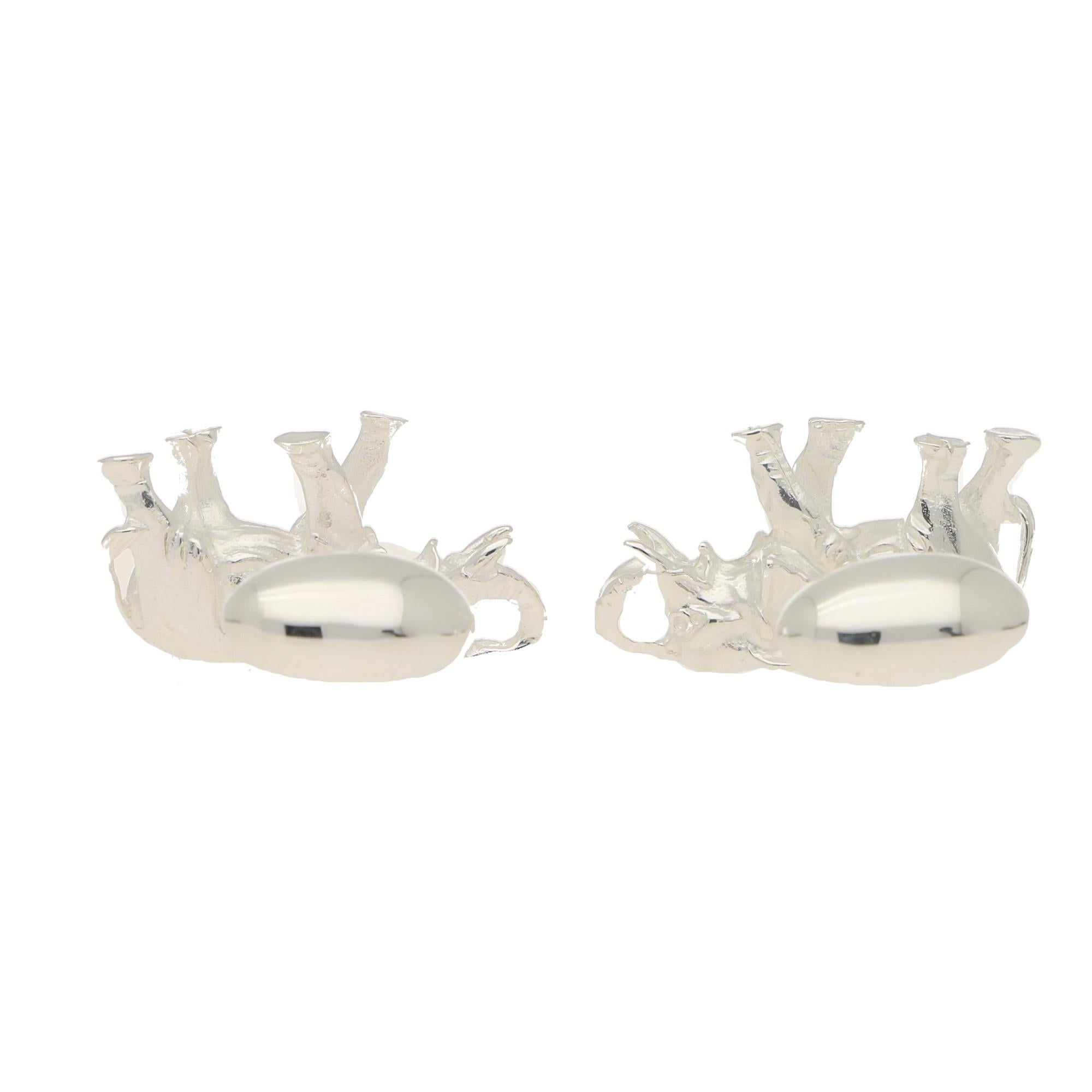A beautifully detailed pair of elephant swivel back cufflinks in solid sterling silver.

Each cufflink depicts a walking elephant with its trunk in the air – a common symbol of good luck. The elephants have been hand crafted and have individual