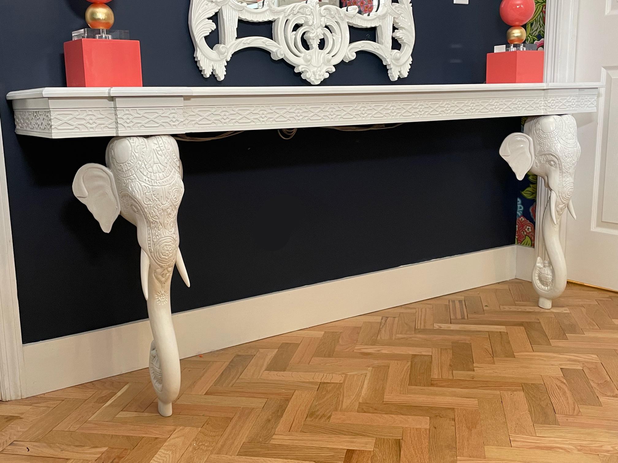 Carved wood wall mount console table by Gampel-Stoll features decorative elephant head legs and fretwork skirt. Rare 6-foot version of this iconic design. Good condition with minor imperfections consistent with age (see photos).
 
 