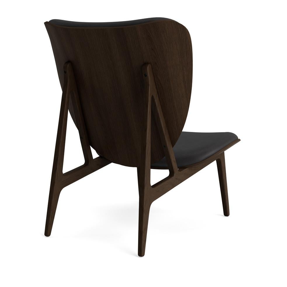 Elephant lounge chair 
Signed by Kristian Sofus Hansen and Tommy Hyldahl for Norr11, 2017

Model shown on the picture:
Wood: Dark Smoked Oak
Fabric: Dunes Anthrancite 21003

Wood types available: natural oak / light smoked oak / dark smoked