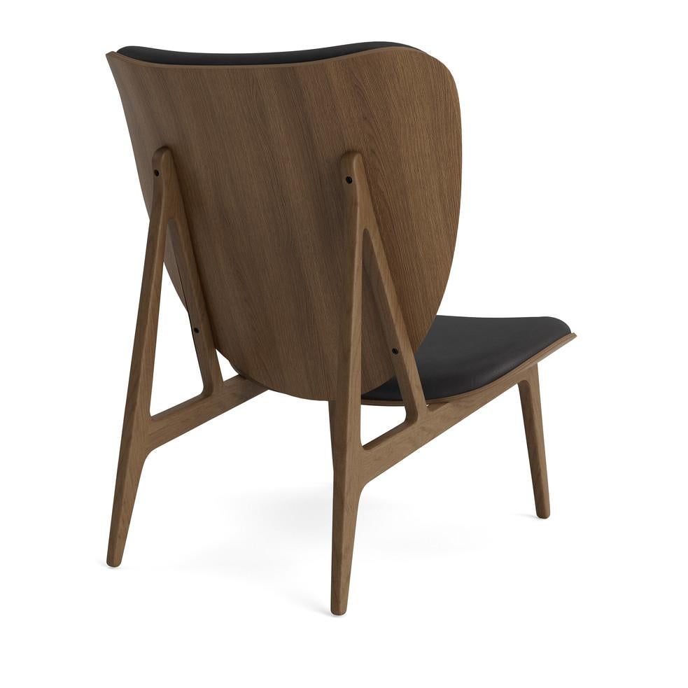 Elephant lounge chair 
Signed by Kristian Sofus Hansen and Tommy Hyldahl for Norr11, 2017

Model shown on the picture:
Wood: Light Smoked Oak
Fabric: Dunes Anthrancite 21003

Wood types available: natural oak / light smoked oak / dark smoked