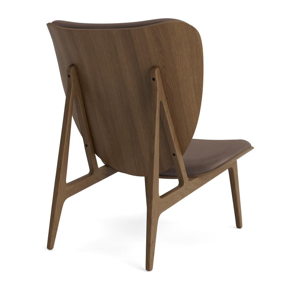 Elephant Lounge Chair 
Signed by Kristian Sofus Hansen and Tommy Hyldahl for Norr11, 2017

Model shown on the picture:
Wood: Light Smoked Oak
Fabric: Dark Brown 21001

Wood types available: natural oak / light smoked oak / dark smoked oak /