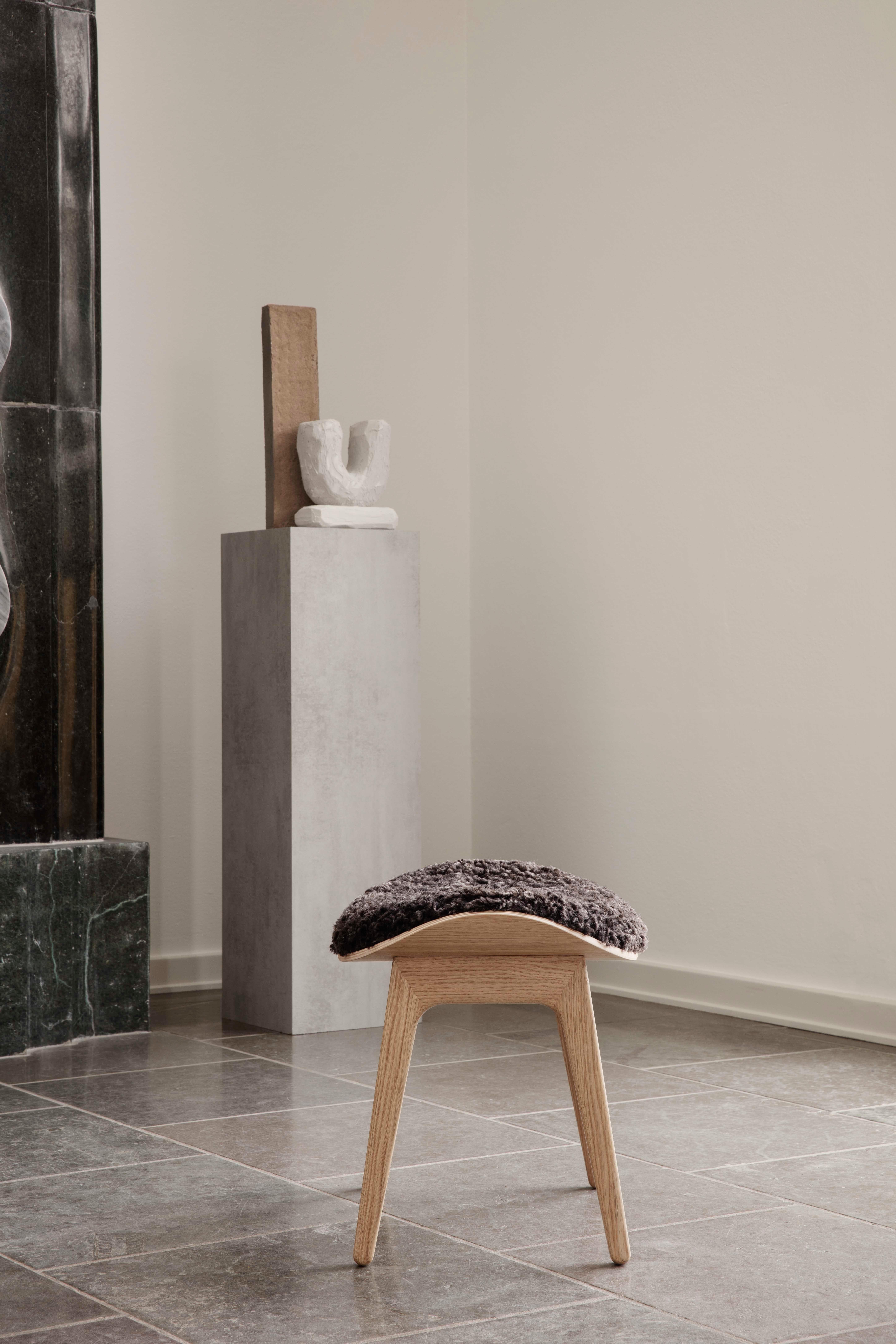 Elephant stool 
Signed by Kristian Sofus Hansen and Tommy Hyldahl for Norr11

Model shown on the picture:
Wood: Natural Oak
Fabric: Sheepskin Espresso
Dimensions: H. 39 x 57 x 41 cm

Wood types available: natural oak / light smoked oak / dark smoked