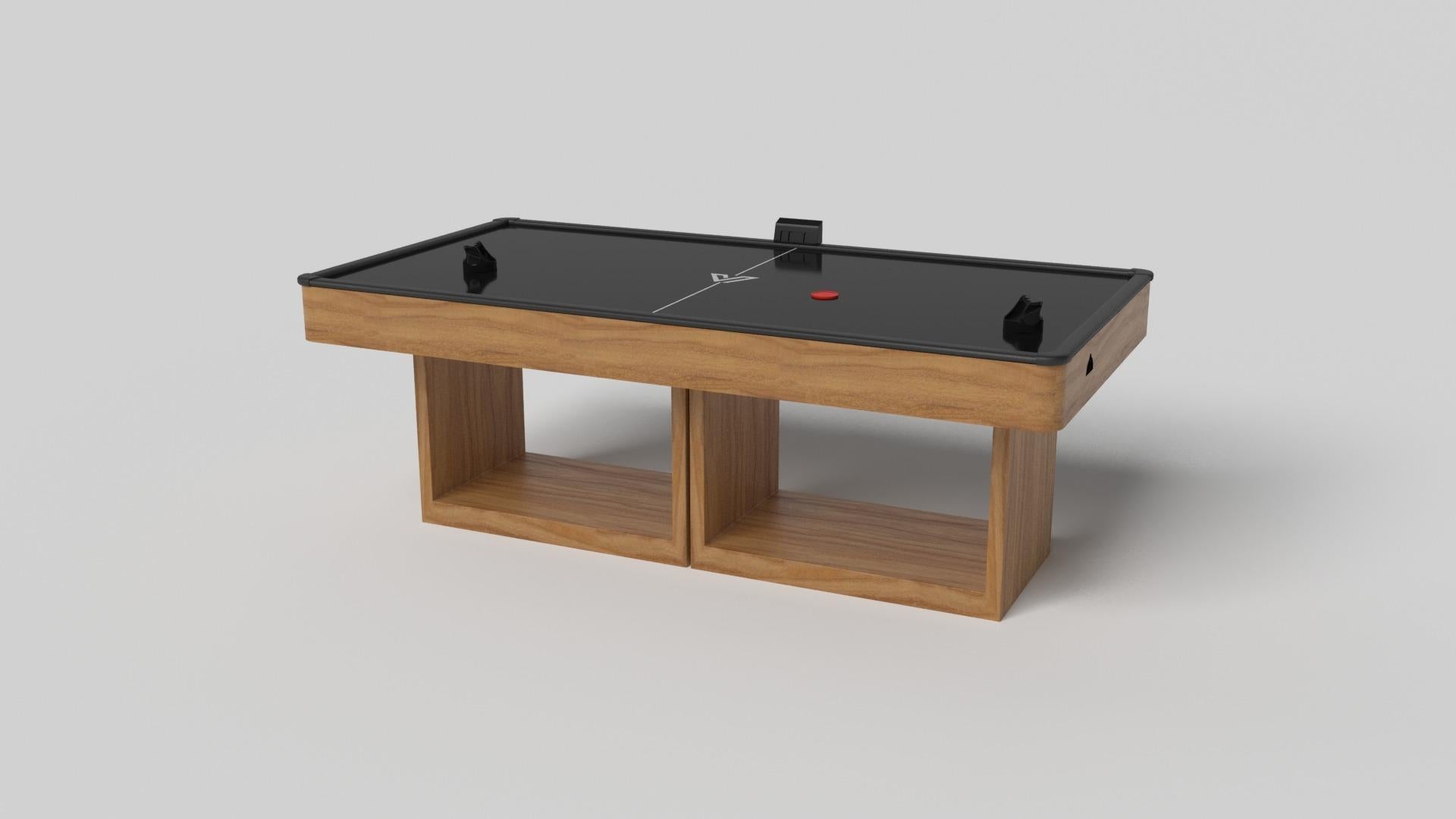 Supported by two rectangular open pedestals as the base, this handcrafted air hockey table is modern and minimalistic with its combination of simple, geometric forms. Viewed from the front, the use of negative space is evident; viewed from the side,