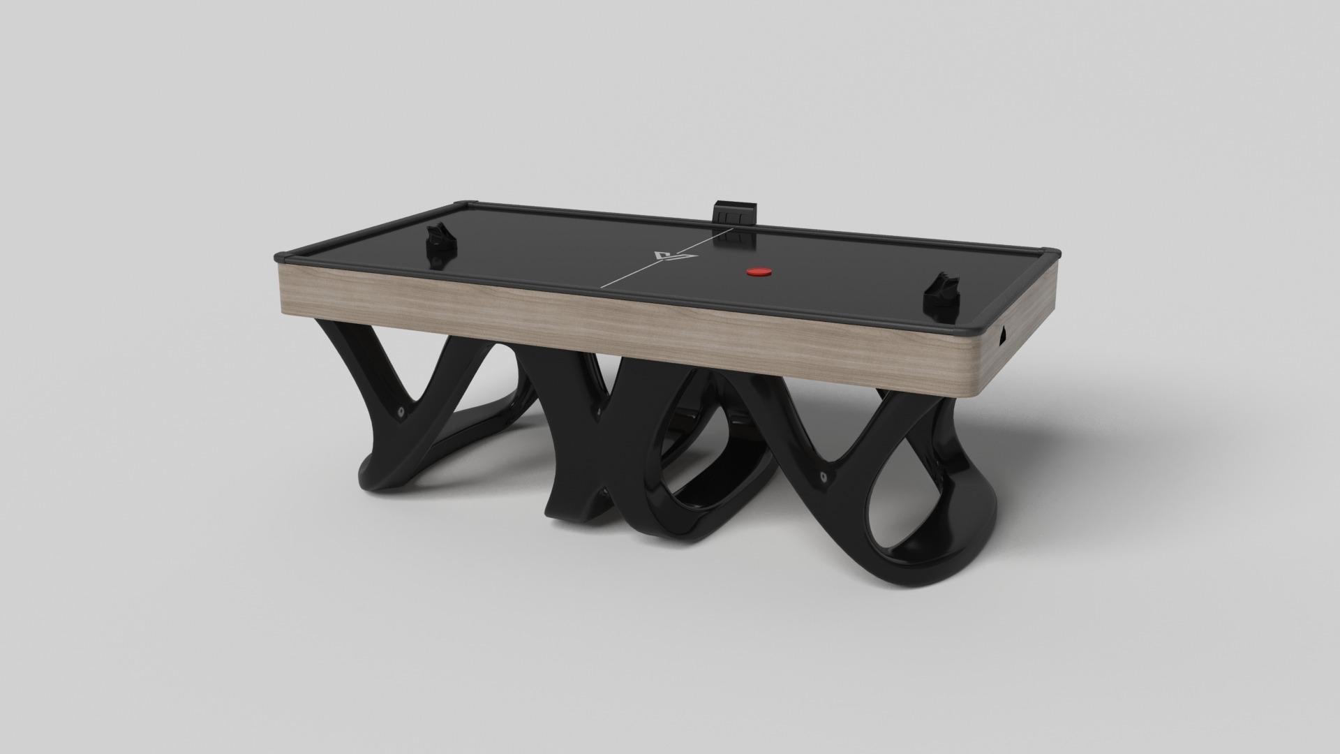 Inspirée par l'œuvre d'Antoni Gaudi et le mouvement du modernisme catalan, la table d'air hockey Draco en noyer affiche un style audacieux avec des pieds lisses et incurvés et un plateau noir net. Fabriquée de manière experte en bois dur, cette
