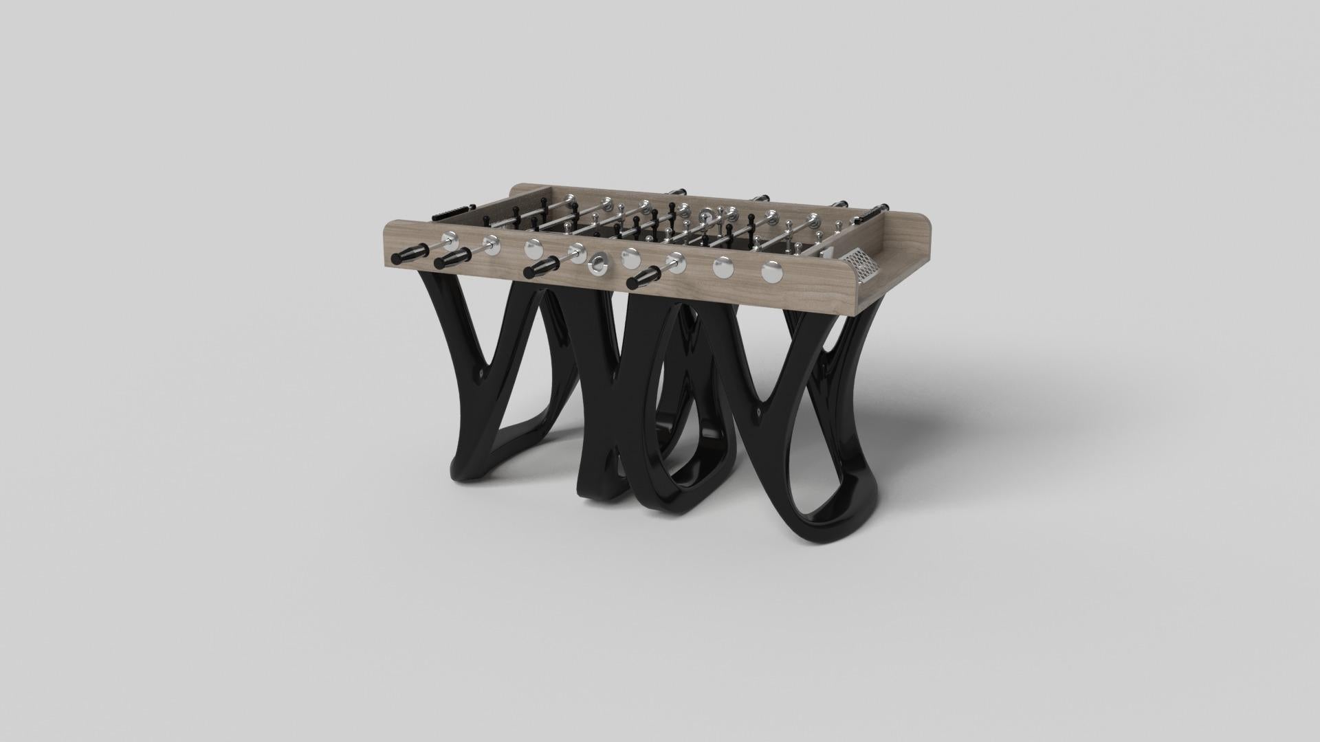 Inspired by the work of Antoni Gaudi and the movement of Catalan Modernism, the Draco foosball table in walnut boasts bold style with smooth, curved legs and a detailed surface for professional game play. Expertly crafted from solid wood, this table