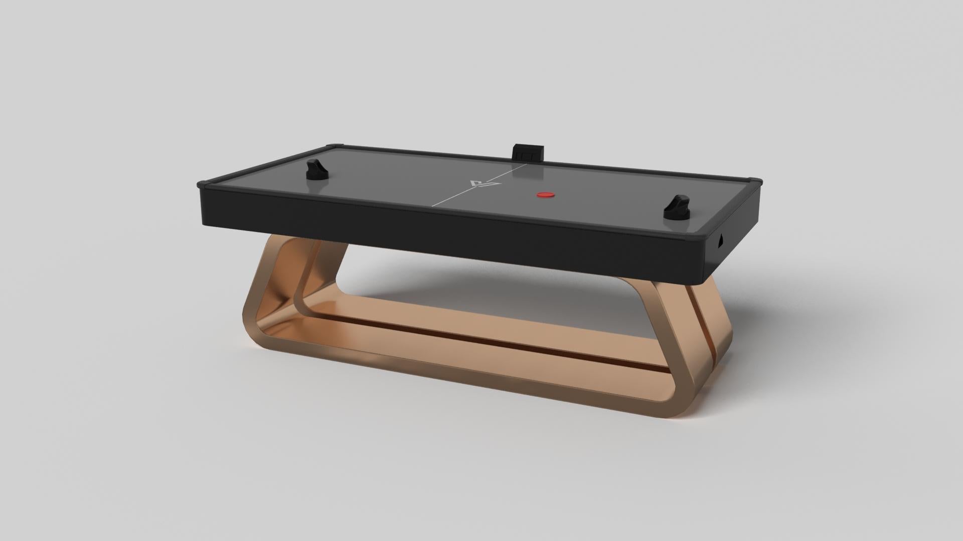 Une base ouverte aux courbes généreuses et aux bords lisses confère une sensation de légèreté à la table de hockey sur gazon Luge en noyer. Évoquant la vitesse et l'esprit de mouvement continu, cette table de jeu exclusive se caractérise par une