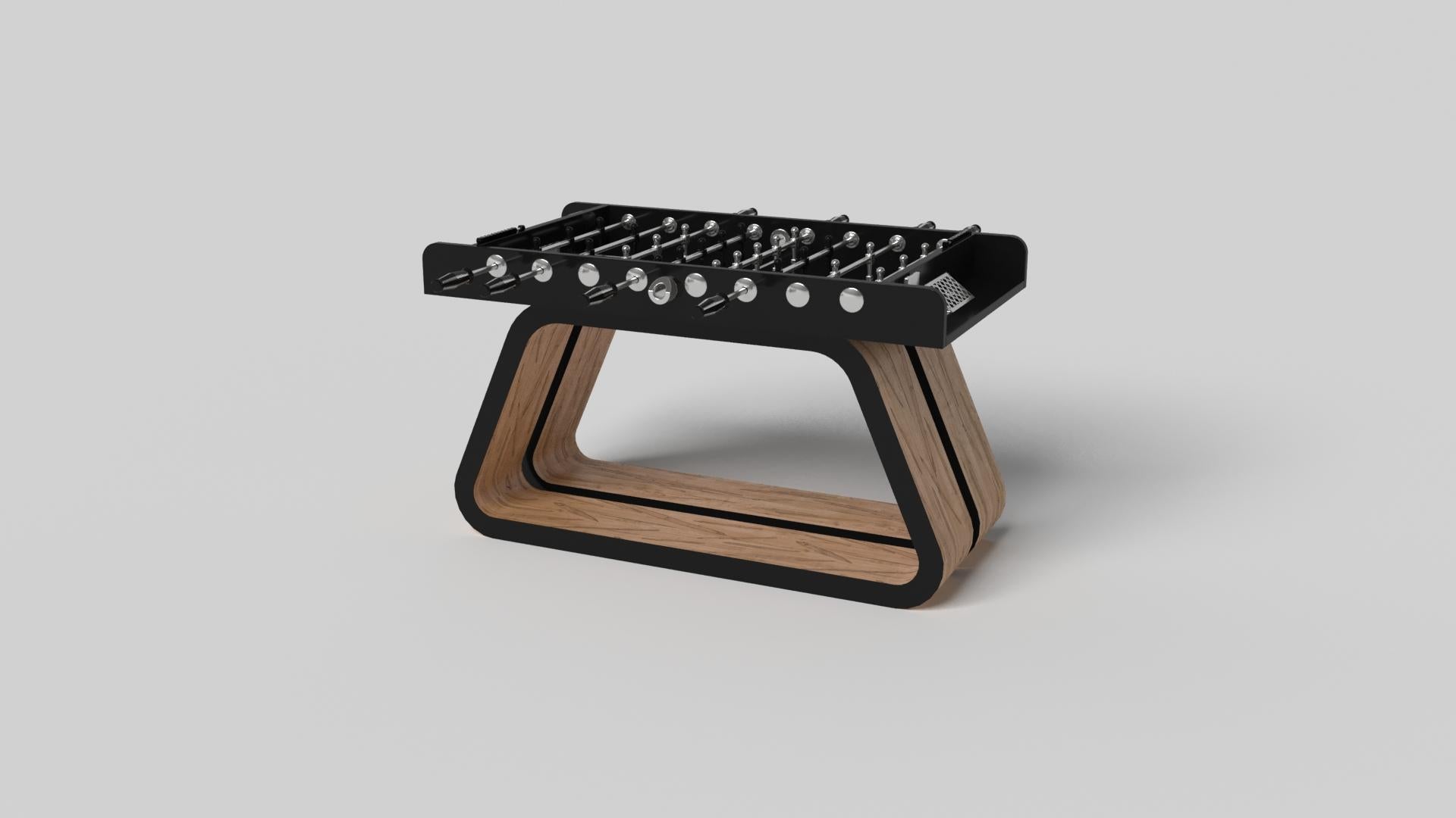 An open base with sweeping curves and smooth edges imparts a light, airy feel upon the Luge foosball table in walnut. Evoking a sense of speed and the spirit of continuous movement, this exclusive wood game table features a split base with open