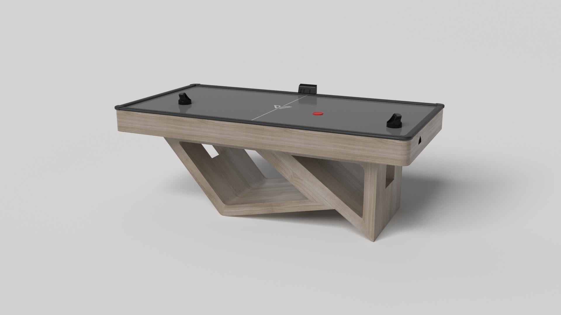 Drawing inspiration from the beauty of geometric forms, the Rumba air hockey table in brushed aluminum is characterized by a series of hollow and solid shapes that form an offset asymmetric base. Accented with a black top for professional game play,