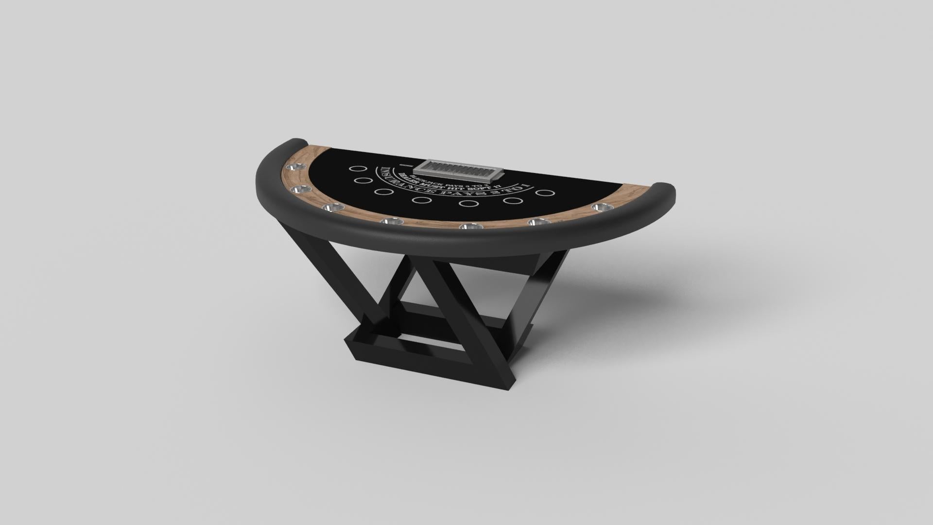 Composition contemporaine de lignes pures et d'arêtes épurées, la table de blackjack Trinity en noir est une expression élégante du design moderne. Fabriquée à la main dans un design semi-circulaire avec un support à jetons et des cercles de paris,