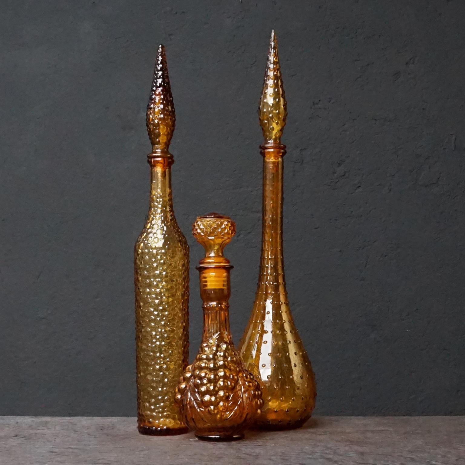 Pressed Eleven 1960s Italian Empoli Rossini Amber Genie Glass Bottles Vase and Candy Jar