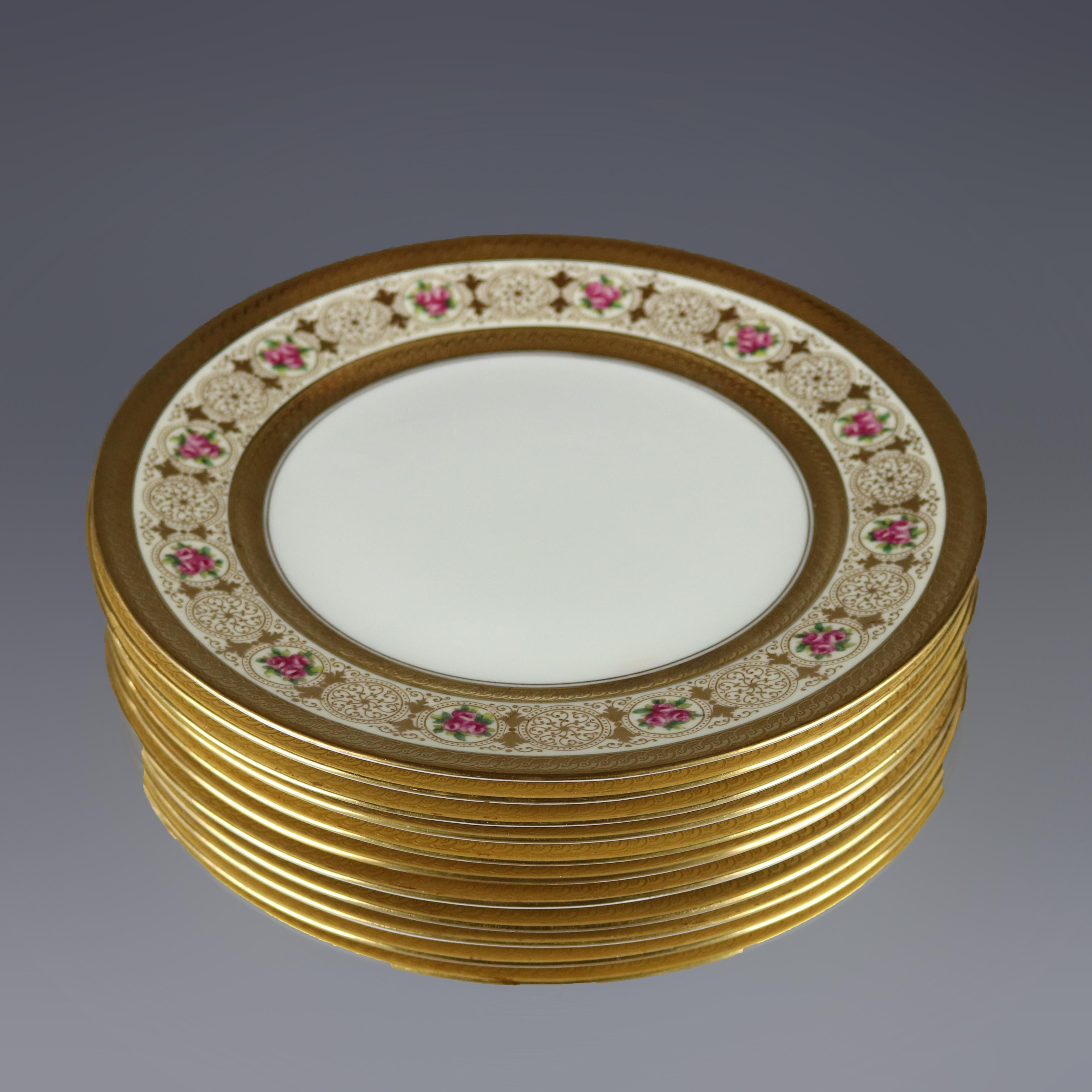 A set of eleven English dinner plates by Cauldon for Beltzer offer heavily gilt rims in scroll and foliate decoration with reserves of roses, maker stamp en verso as photographed, 20th century.

Measures: .75