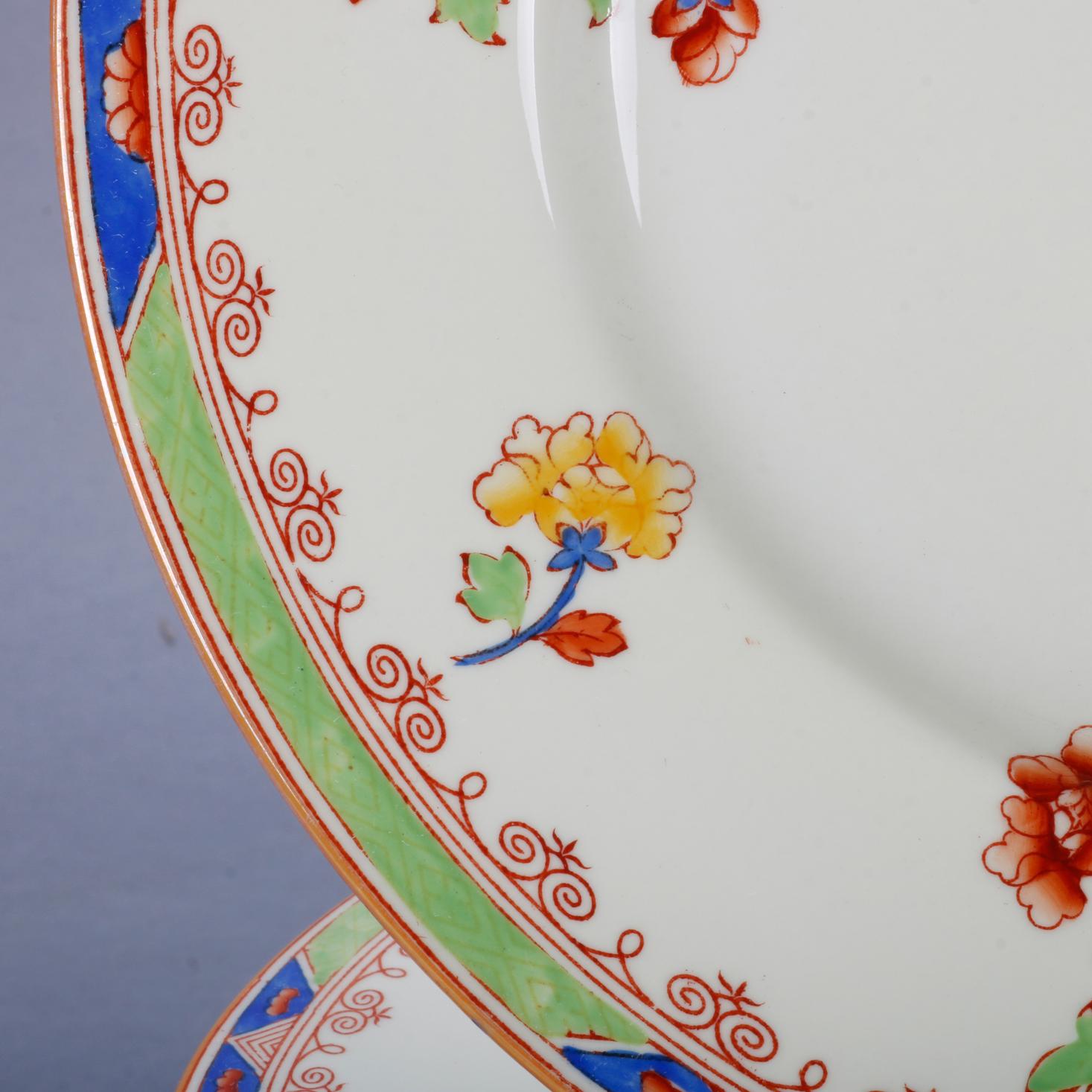 A vintage set of eleven Aesthetic Movement Copeland Spode for Tiffany porcelain dinner plates offer stylized rim having detached floral spray, maker mark en verso as photographed, circa 1930.

Measures: 10.25