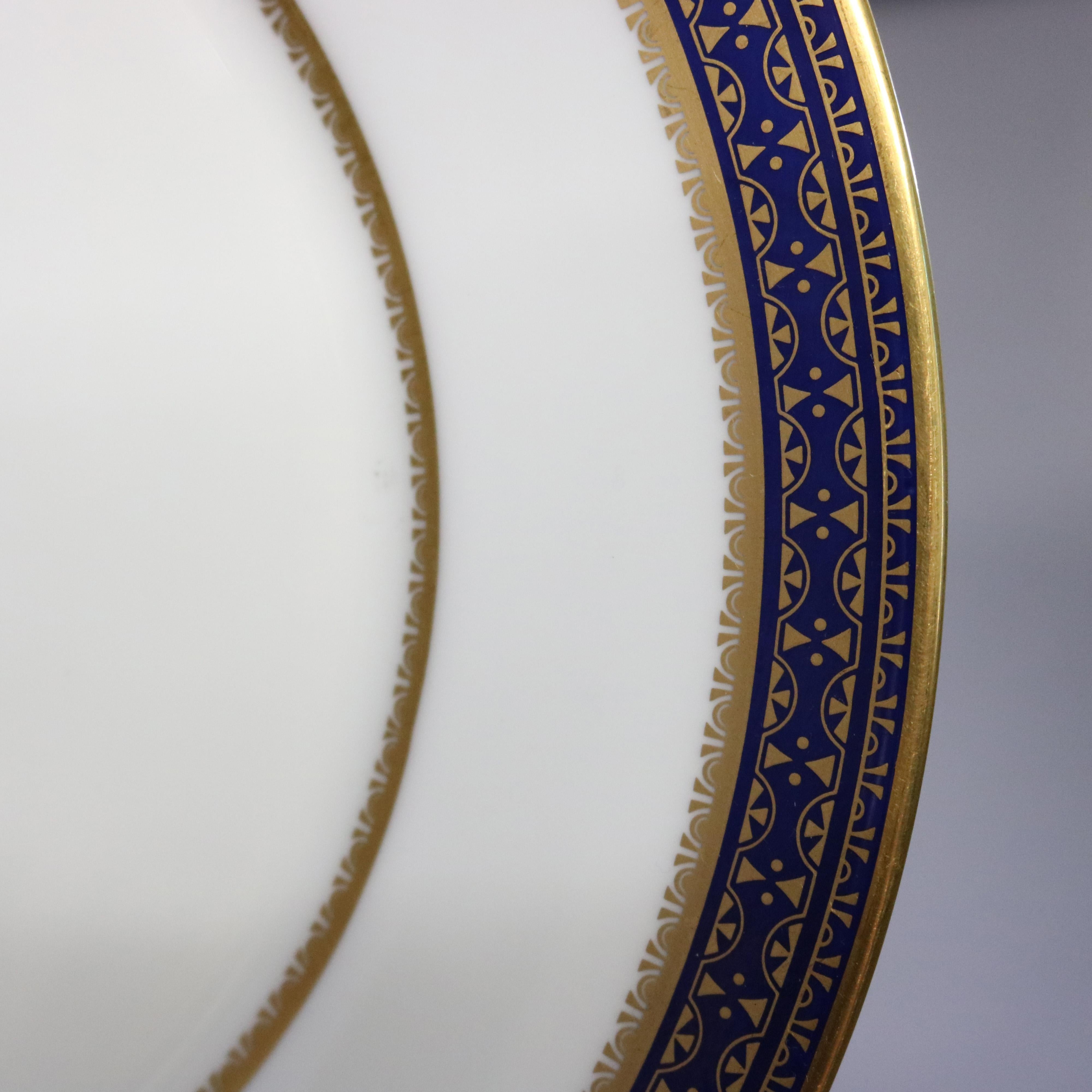 A set of 11 English Oxford bone China dinner plates offer cobalt blue bordering with gold gilt highlights, en verso maker mark as photographed, 20th century

Measures- 0.88