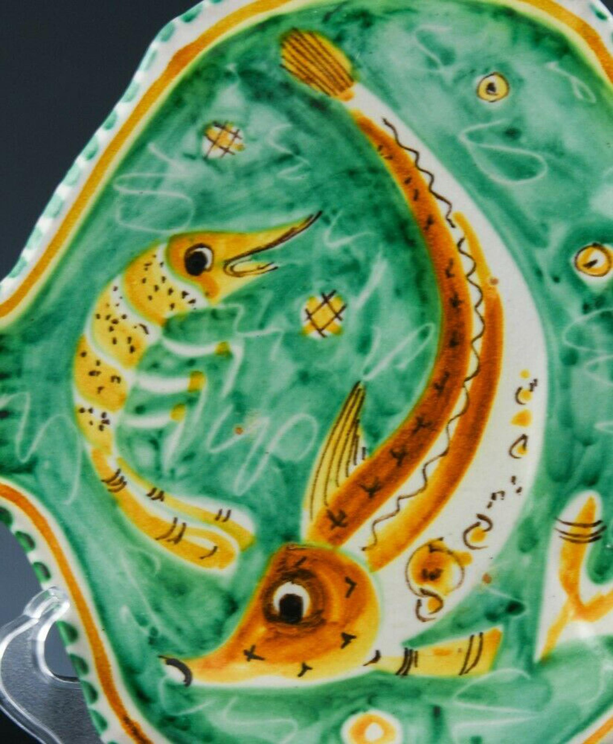 Eleven Mid-Century Modern Italian pottery fish plates,
Vietri
Dated 1958,

Each plate is modeled in the form of a fish and each is painted with a different fish or sea life on an orange and green ground.

Mark: C.A.S/ Vietri/Italy/ AD