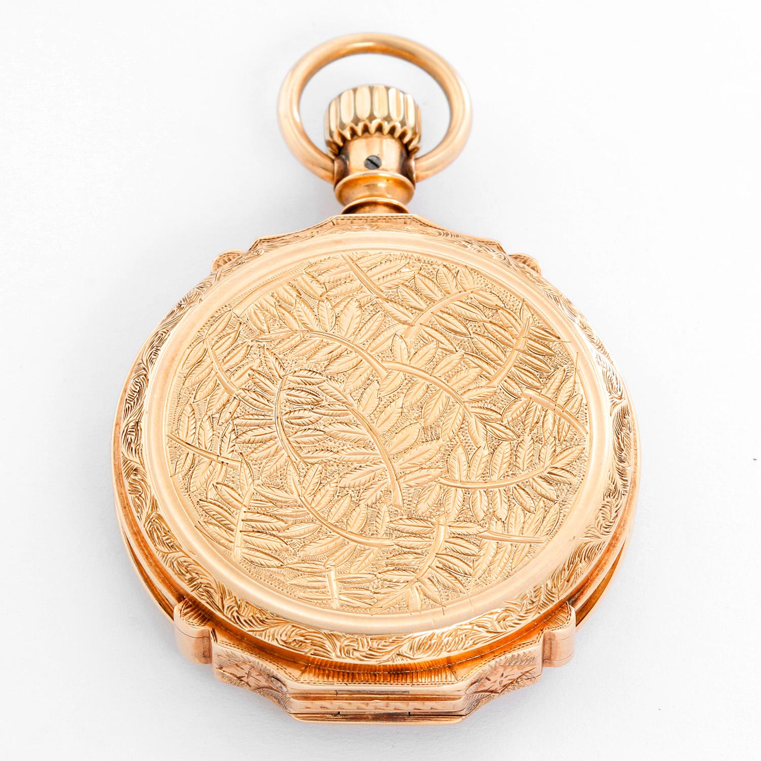 Elgin 14K Yellow Gold Hinge Pocket Watch - Manual winding. 14K Yellow gold ( 43 mm) with ornate engraving on borth front and back . White dial with Roman numerals; subsecond dial at 6 o'clock. Pre-owned with custom box. 
Please note that this watch