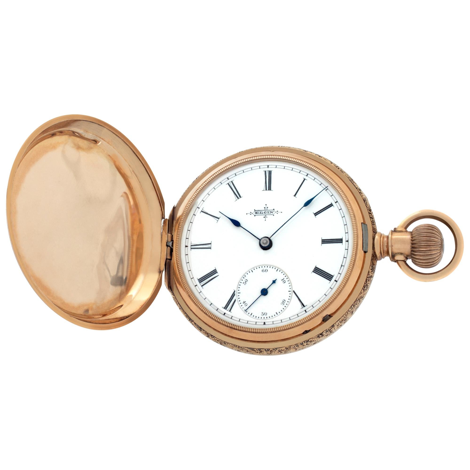Elgin pocket watch in 14k yellow gold with floral design hunter case. 8 size (36mm case size). Manual wind with sub-seconds. Roman numeral dial. Fine Pre-owned Elgin Watch. Certified preowned Vintage Elgin pocket watch watch is made out of yellow