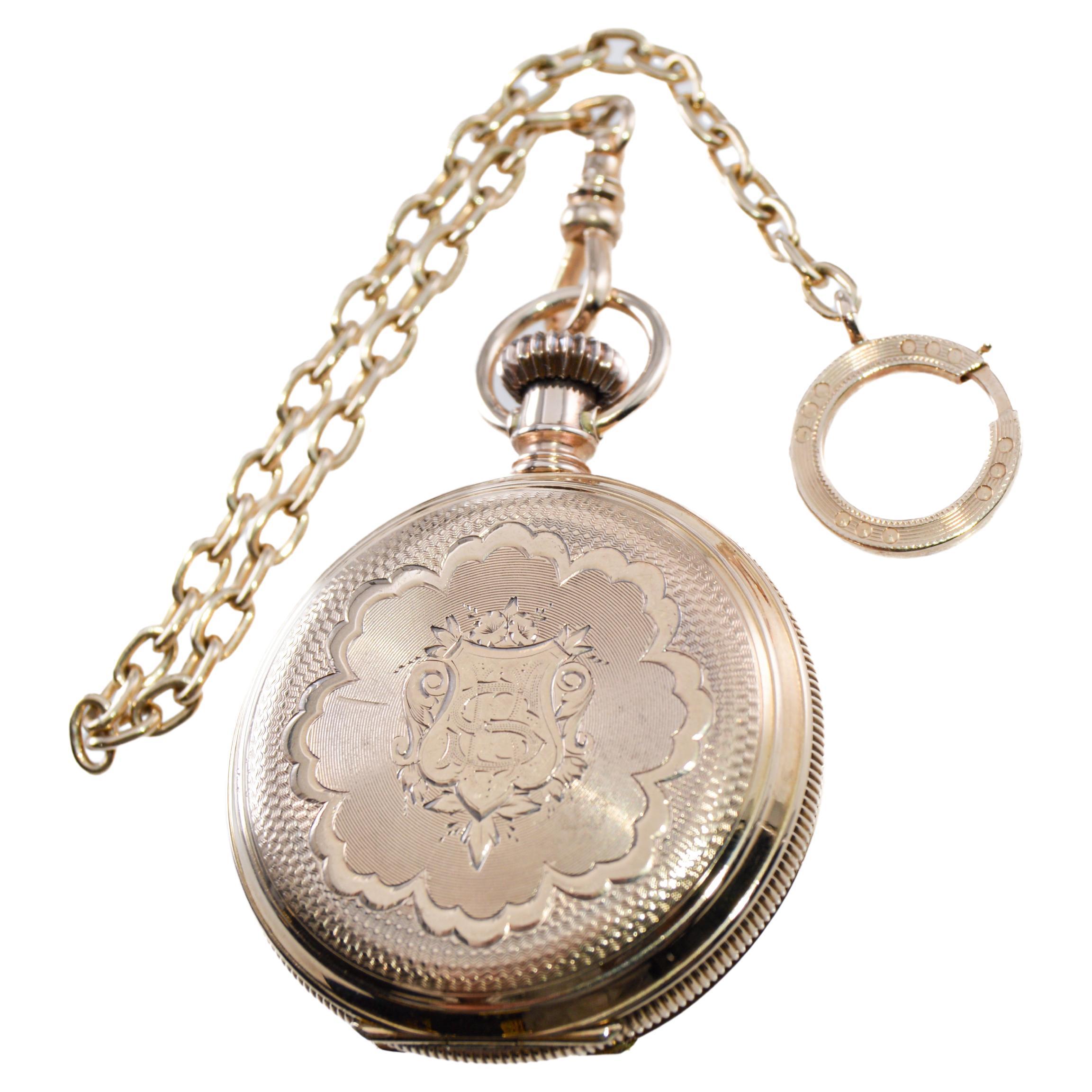 FACTORY / HOUSE: Elgin Watch Company
STYLE / REFERENCE: Hunters Case Pocket Watch
METAL / MATERIAL: 14Kt. Solid Gold / Supplied with a Solid Gold Pocket Watch Chain
CIRCA / YEAR: 1887
DIMENSIONS / SIZE: Length & Diameter 40mm
MOVEMENT / CALIBER: