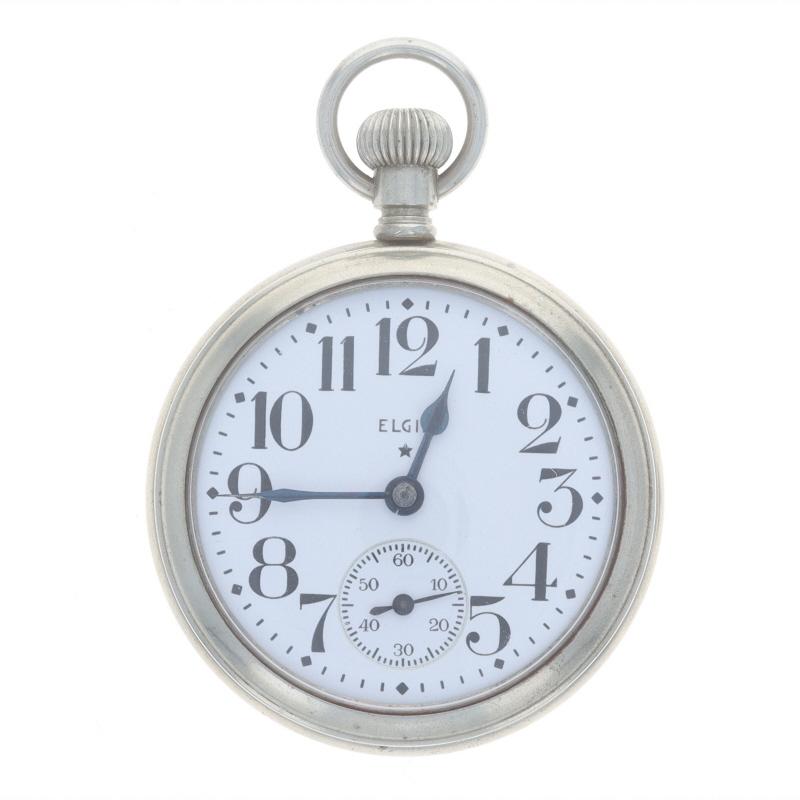 Marke: Elgin
Modell: 15 Vater Zeit
Bewegung: Manuell
Anzahl der Juwelen: 21
Jahr: 1917
Zifferblattfarbe: Weiß

Klasse: 388
Größe: 16s

Metallgehalt: Silber getönt

Stil: Offenes Gesicht
Merkmale: 
Koffer des Verkäufers
Hilfszifferblatt bei der