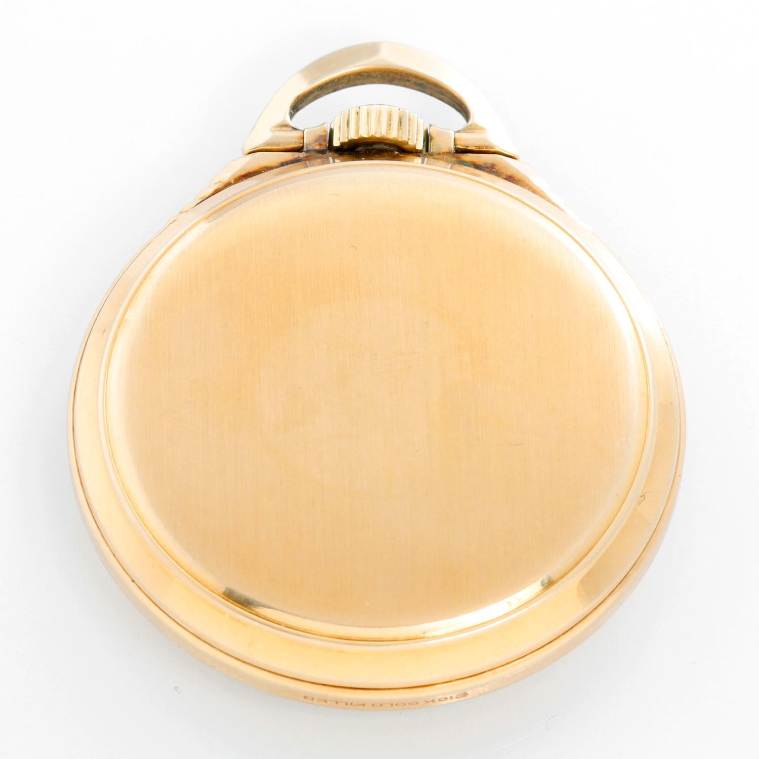 Elgin 23J BW Raymond Pocket Watch - Manual winding; 23 Jewel. 10K Gold filled ( 50 mm). Up and down indicator with 24 hour dial; White with Arabic numerals and sunken subdials . Very hard to find in this condition. Circa 1934. Pre-owned with