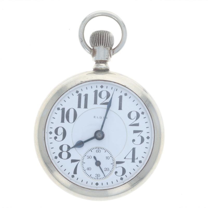 Brand: Elgin
Model: 15 B.W. Raymond
Movement: Mechanical
Number of Jewels: 19
Year: 1921
Movement Maker: United States
Dial Color: White

Grade: 455 
Size: 16s 

Metal Content: Silver Toned

Style: Open Face
Features: 
Numbers marking the hours 