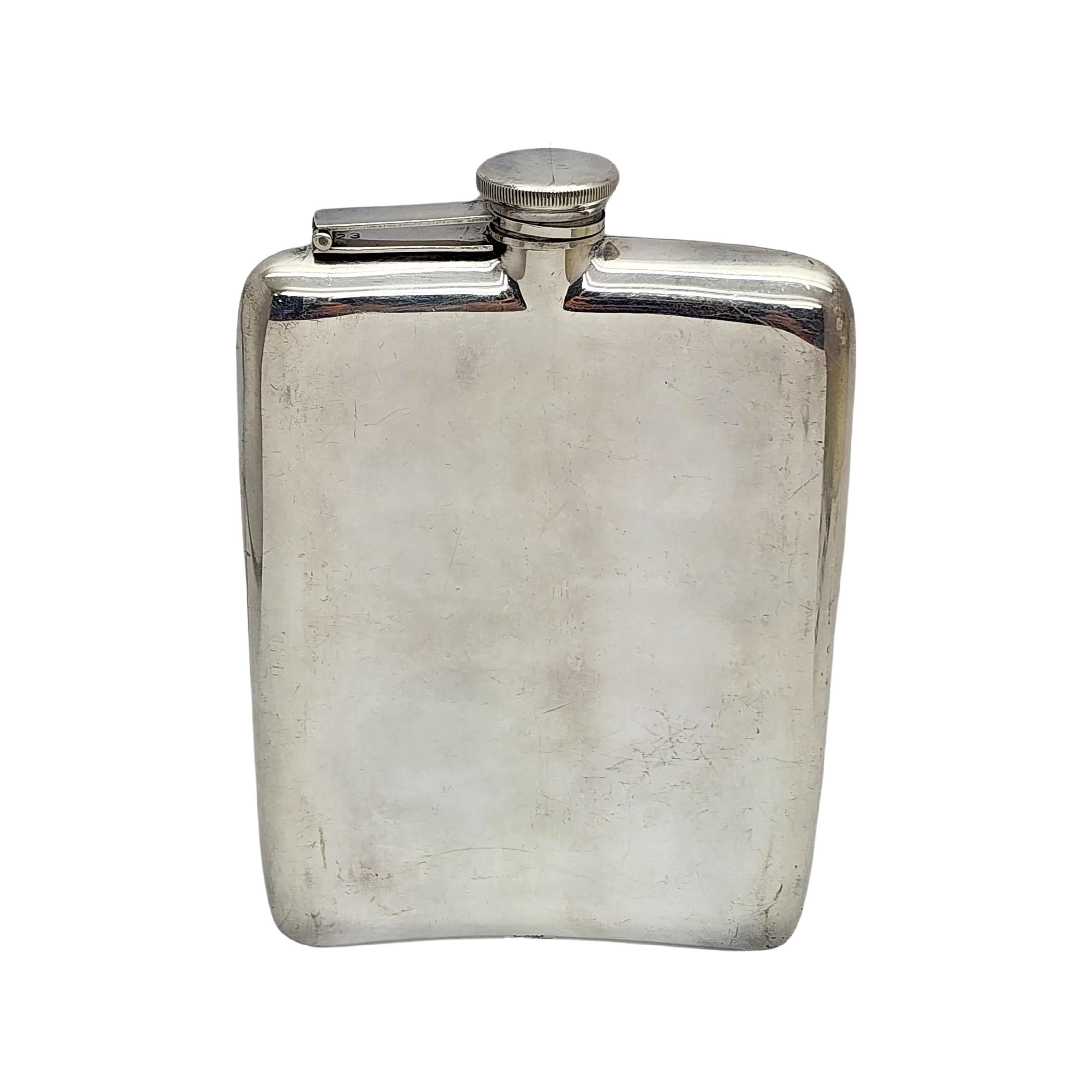 Sterling silver hip flask by EAM, Elgin American Manufacturing Co, with monogram.

Monogram appears to be BAM

Curved hip flask featuring alternating etched stripes and a smooth polished finish stripe on the front, a smooth polished finish on the
