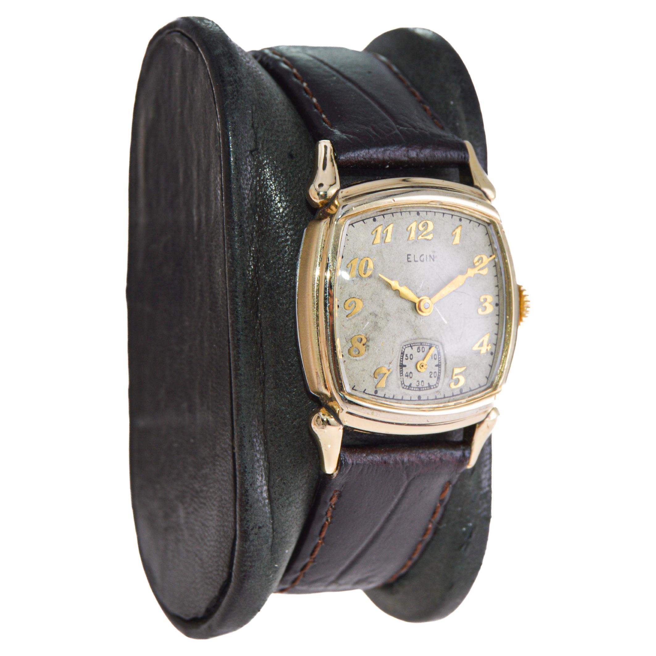 FACTORY / HOUSE: Elgin Watch Company
STYLE / REFERENCE: Cushion Shaped
METAL / MATERIAL: Gold Filled
CIRCA / YEAR: 1940's
DIMENSIONS / SIZE: Length 35mm X Width 25mm
MOVEMENT / CALIBER: Manual Winding / 15 Jewels / Caliber 
DIAL / HANDS: Original