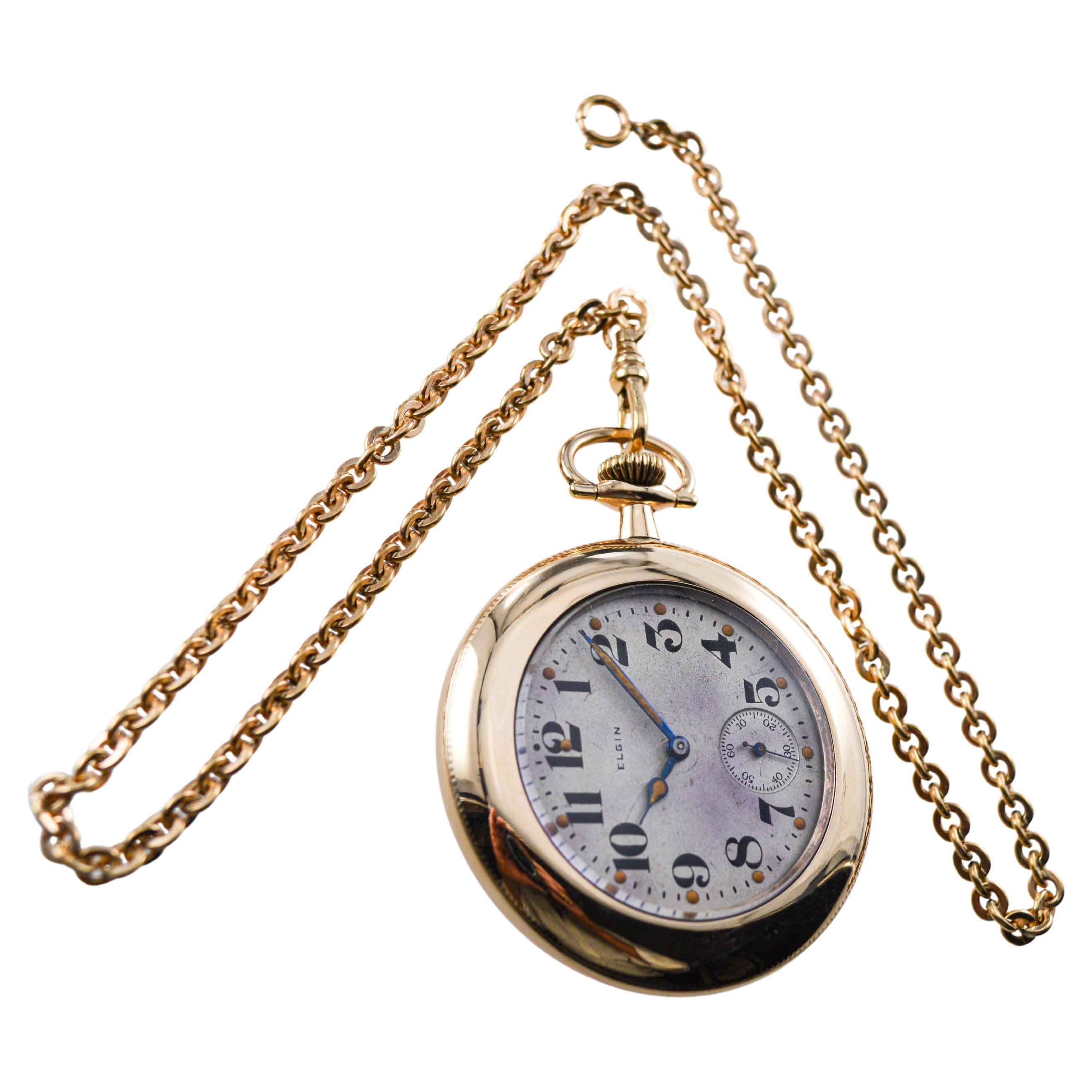 FACTORY / HOUSE: Elgin Watch Company
STYLE / REFERENCE: Open Faced Pocket Watch
METAL / MATERIAL: Yellow Gold Filled
CIRCA / YEAR: 1916
DIMENSIONS / SIZE: Diameter 47mm
MOVEMENT / CALIBER: Manual Winding / 7 Jewels / Caliber 12 Size
DIAL / HANDS: