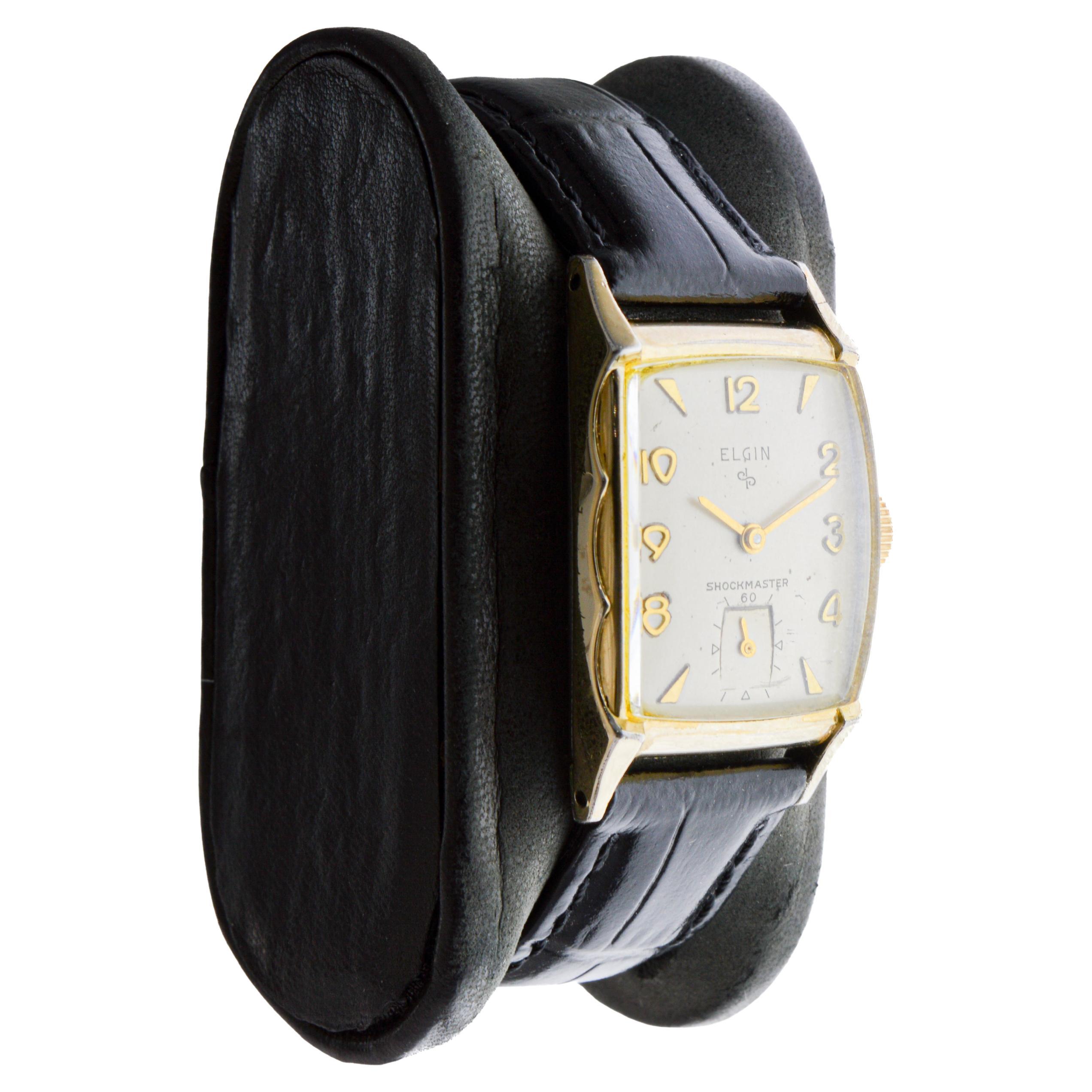 FACTORY / HOUSE: Elgin Watch Company
STYLE / REFERENCE: Shockmaster / Tonneau Shape
METAL / MATERIAL: Yellow Gold Filled
CIRCA / YEAR: 1940's
DIMENSIONS / SIZE: Length 36 X Width 22
MOVEMENT / CALIBER: Winding / 17 Jewels / Caliber 15-0
DIAL /