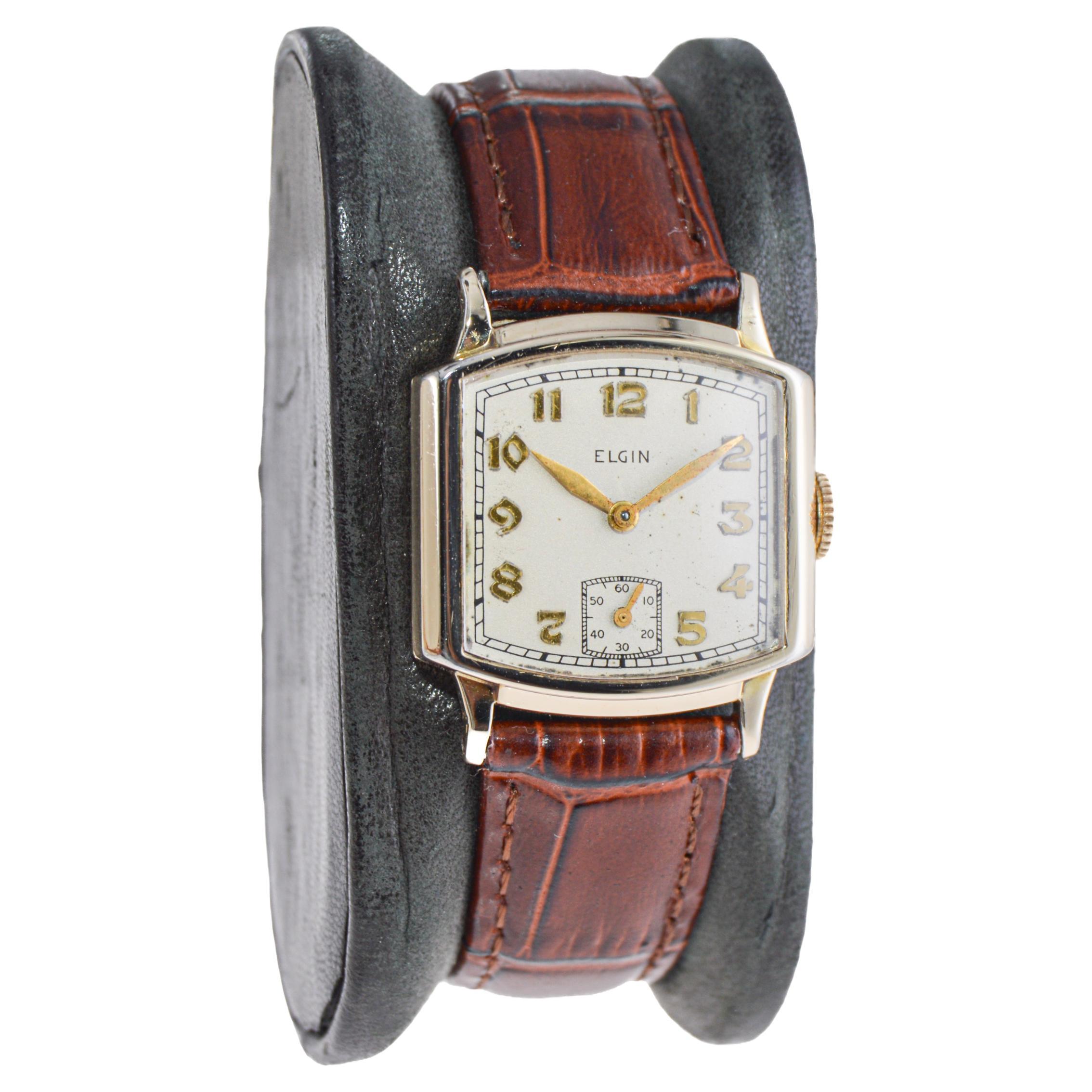 FACTORY / HOUSE: Elgin Watch Company
STYLE / REFERENCE: Art Deco / Tank Style
METAL / MATERIAL: Gold-Filled
CIRCA / YEAR: 1940's
DIMENSIONS / SIZE: Length 31mm X Width 26mm
MOVEMENT / CALIBER: Manual Winding / 21 Jewels 
DIAL / HANDS: Original