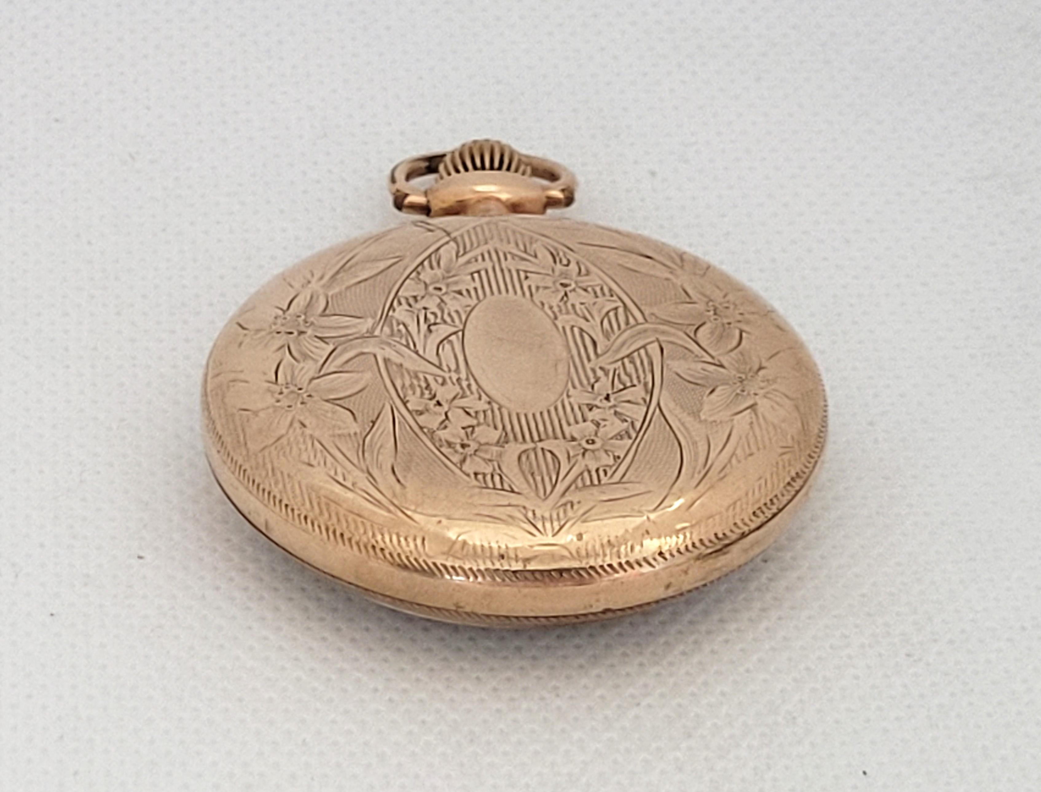 Elgin 1911  gold plated pocket watch with a 44mm case that is 11mm thick and a clean plastic crystal accented with a beautiful floral design. The 17 Jewel manual movement is working, serial number 15612909. Overall, this watch is in very good