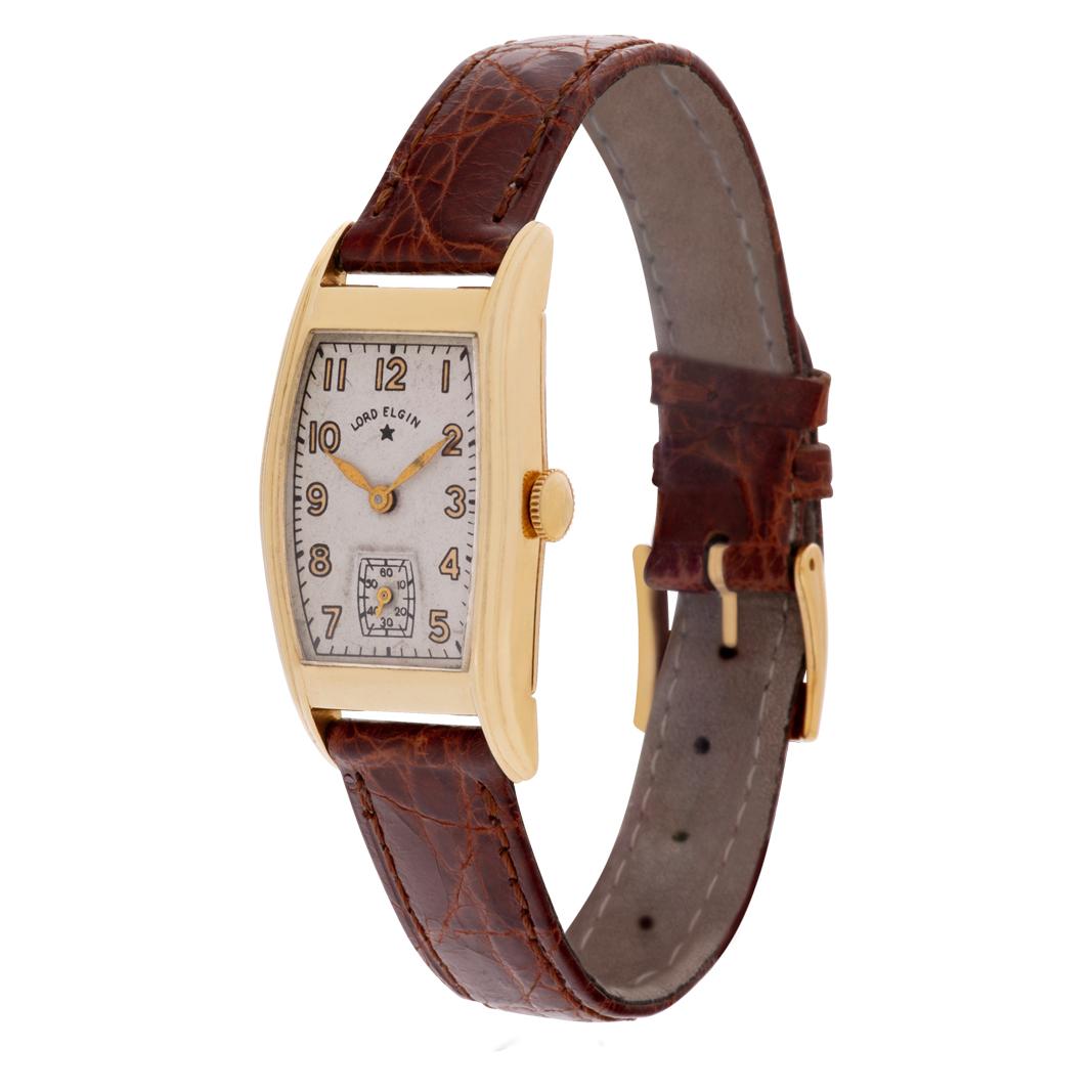 Vintage Lord Elgin with rectangular 14k case on leather strap. With subseconds. Circa 1930s. Fine Pre-owned Elgin Watch.

Certified preowned Vintage Elgin Lord Elgin watch is made out of yellow gold on a Tan Leather strap with a Gold Fill tang