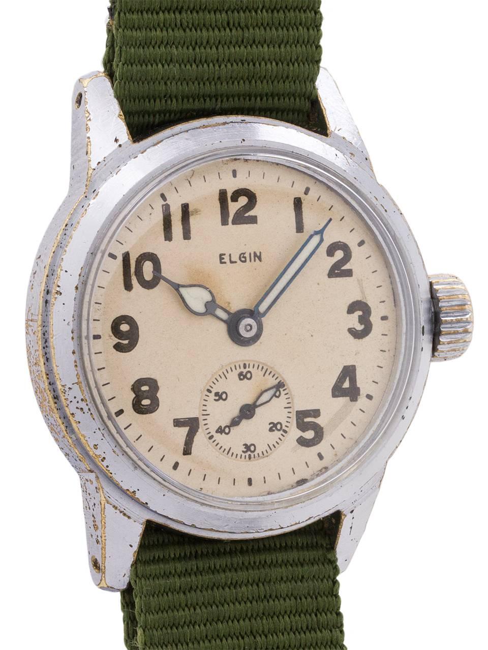 
A popular vintage Elgin military issue model circa WWII. Medium size 32mm diameter base metal case, with stainless steel screw down caseback with U.S. ordinance engraving. Chromium plated bezel shows wear consistent with use in the military. With
