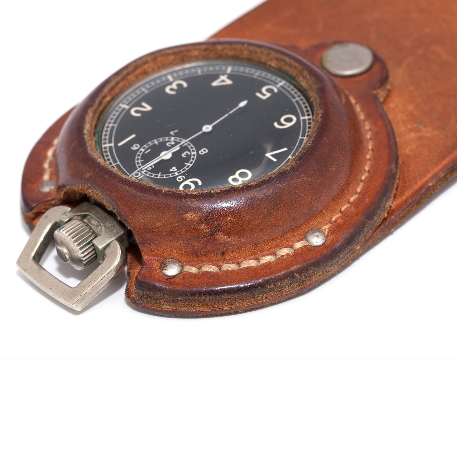  An equestrians stop watch suspended in a leather holster in excellent shape.